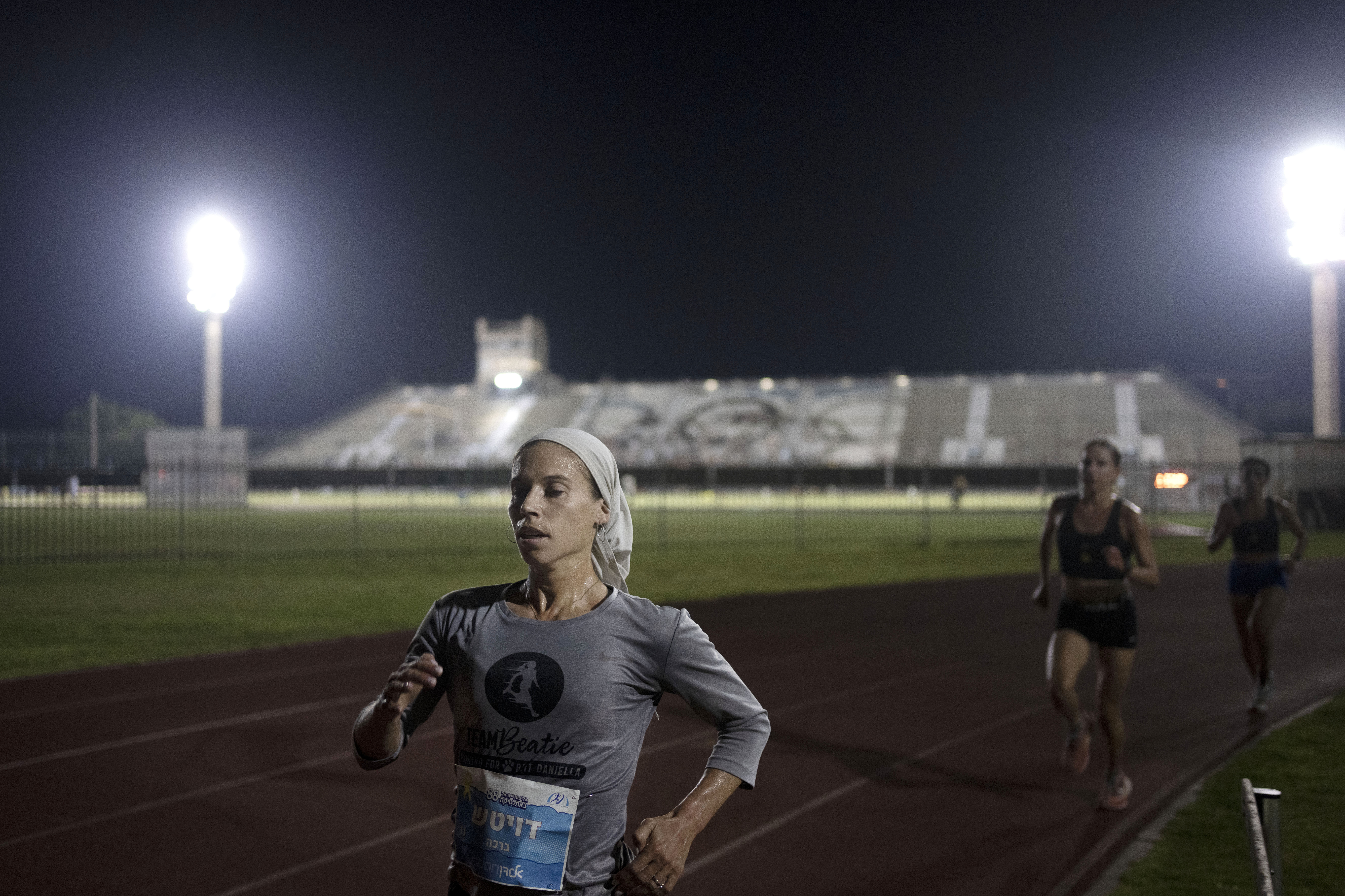 Beatie Deutsch, an Orthodox Jewish runner, trains in Tel Aviv, Israel, Wednesday, June 26, 2024. "I'd love governing bodies of sports to do more to accommodate religion," said the 34-year-old mother of five. She qualified to represent Israel in the 2020 Tokyo Olympics but didn't compete because the women's marathon was scheduled for a Saturday, when she observes shabbat. 