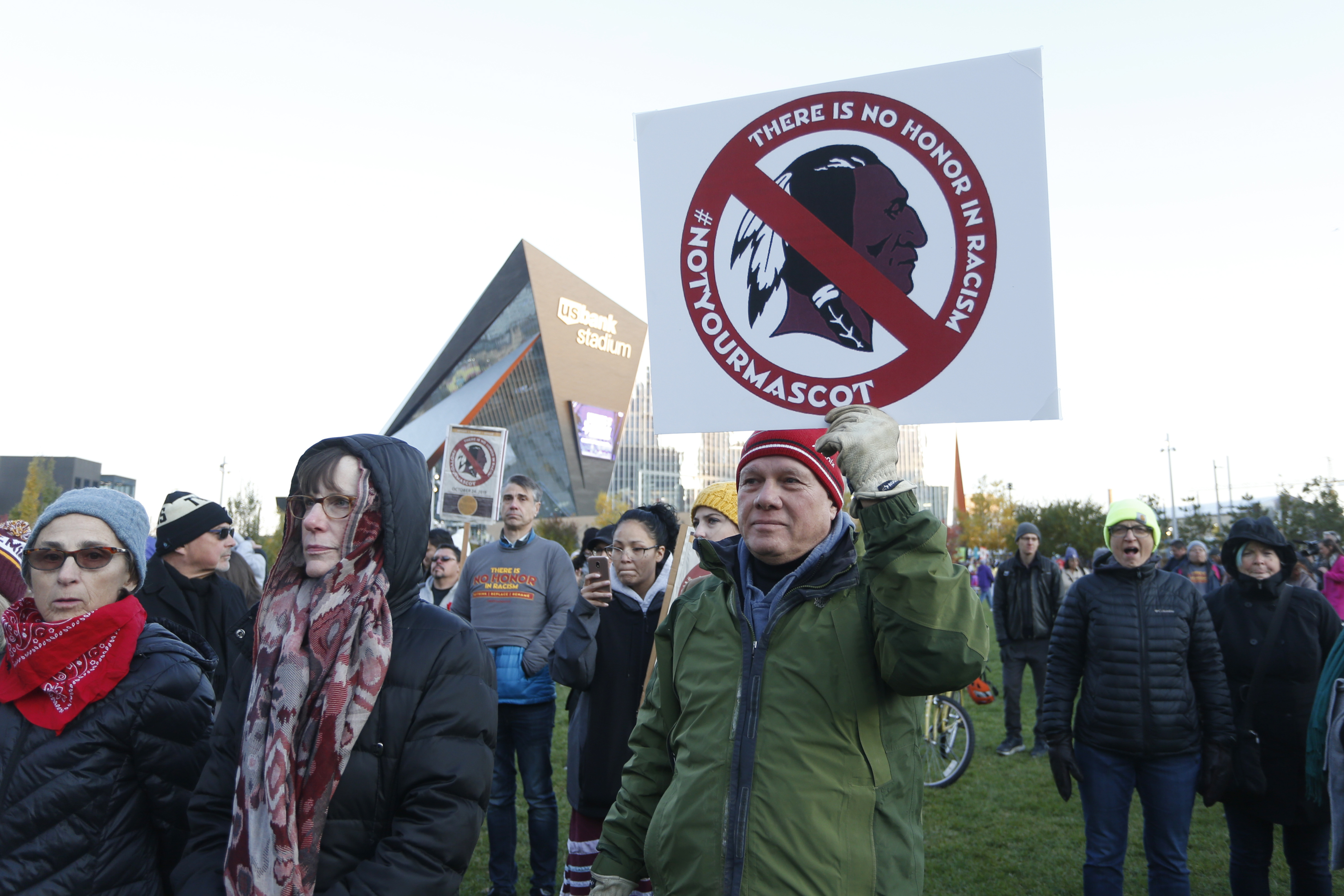 FILE - In this Oct. 24, 2019, file photo, Native American leaders protest against the Redskins team name and logo outside U.S. Bank Stadium before an NFL football game between the Minnesota Vikings and the Washington Redskins in Minneapolis. Many Native Americans thought a bitter debate over the U.S. capital's football mascot was over when the team became the Washington Commanders. The original logo was designed by a member of the Blackfeet Nation. Now a white Republican U.S. senator from Montana is reviving the debate by blocking a bill funding the revitalization of the team's stadium unless the NFL and the Commanders bring back the former logo in some form. 