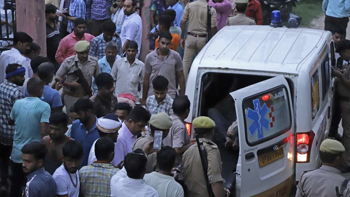 An injured person arrives in an ambulance at the Sikandrarao hospital in Hathras district in India, Tuesday. At least 105 people are dead and scores are injured after a stampede, officials said Tuesday.