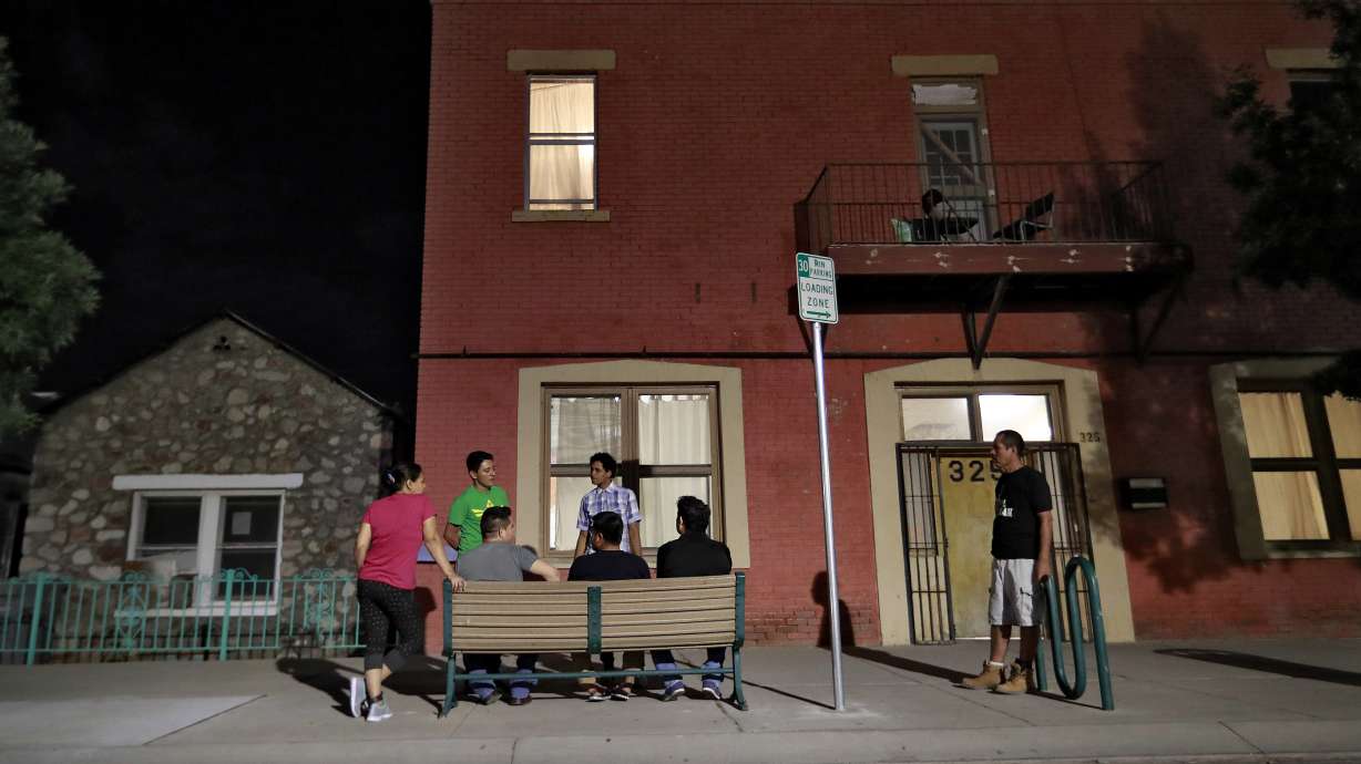 Migrant parents socialize outside the Annunciation House, June 26, 2018, in El Paso, Texas. A Texas judge ruled Tuesday against efforts to shut down a migrant shelter in El Paso that the Texas attorney general claimed encourages illegal migration.