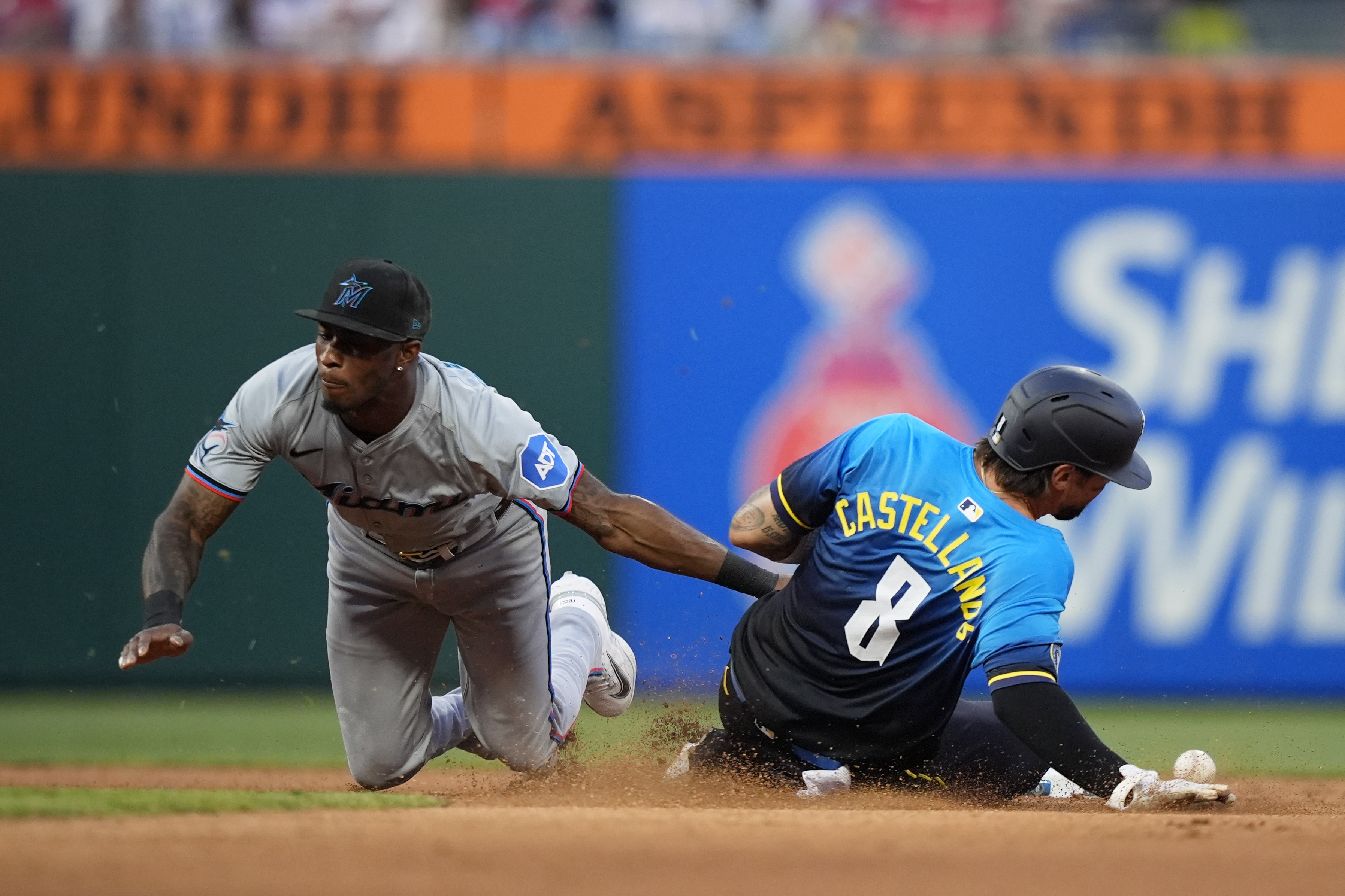 Philadelphia Phillies' Nick Castellanos, right, steals second past Miami Marlins shortstop Tim Anderson during the seventh inning of a baseball game, Friday, June 28, 2024, in Philadelphia. 