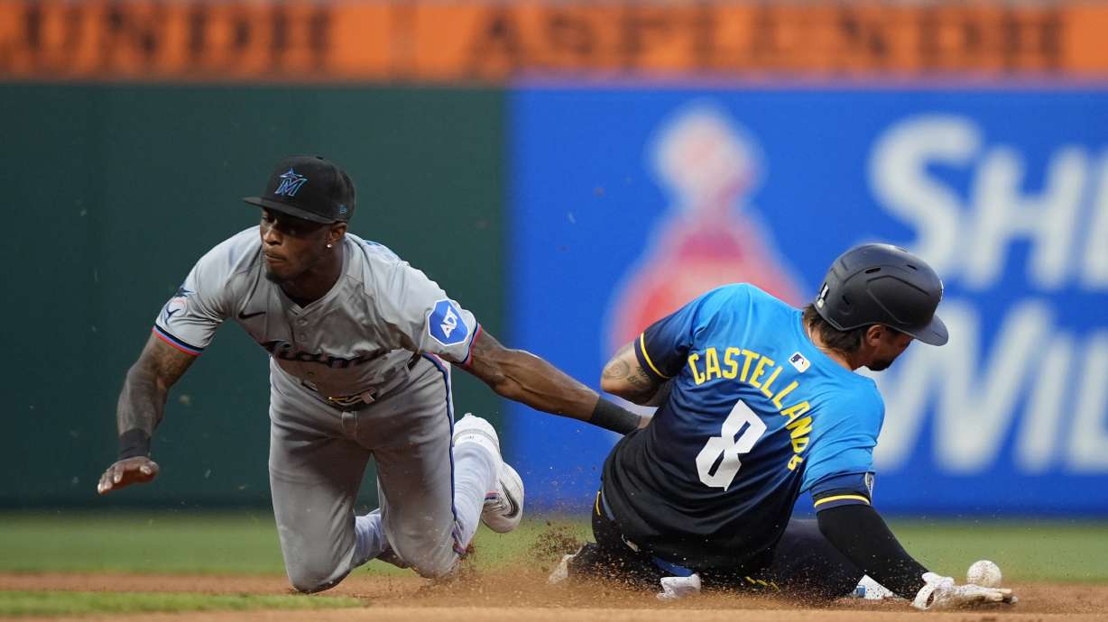 Philadelphia Phillies' Nick Castellanos, right, steals second past Miami Marlins shortstop Tim Anderson during the seventh inning of a baseball game, Friday, June 28, 2024, in Philadelphia.