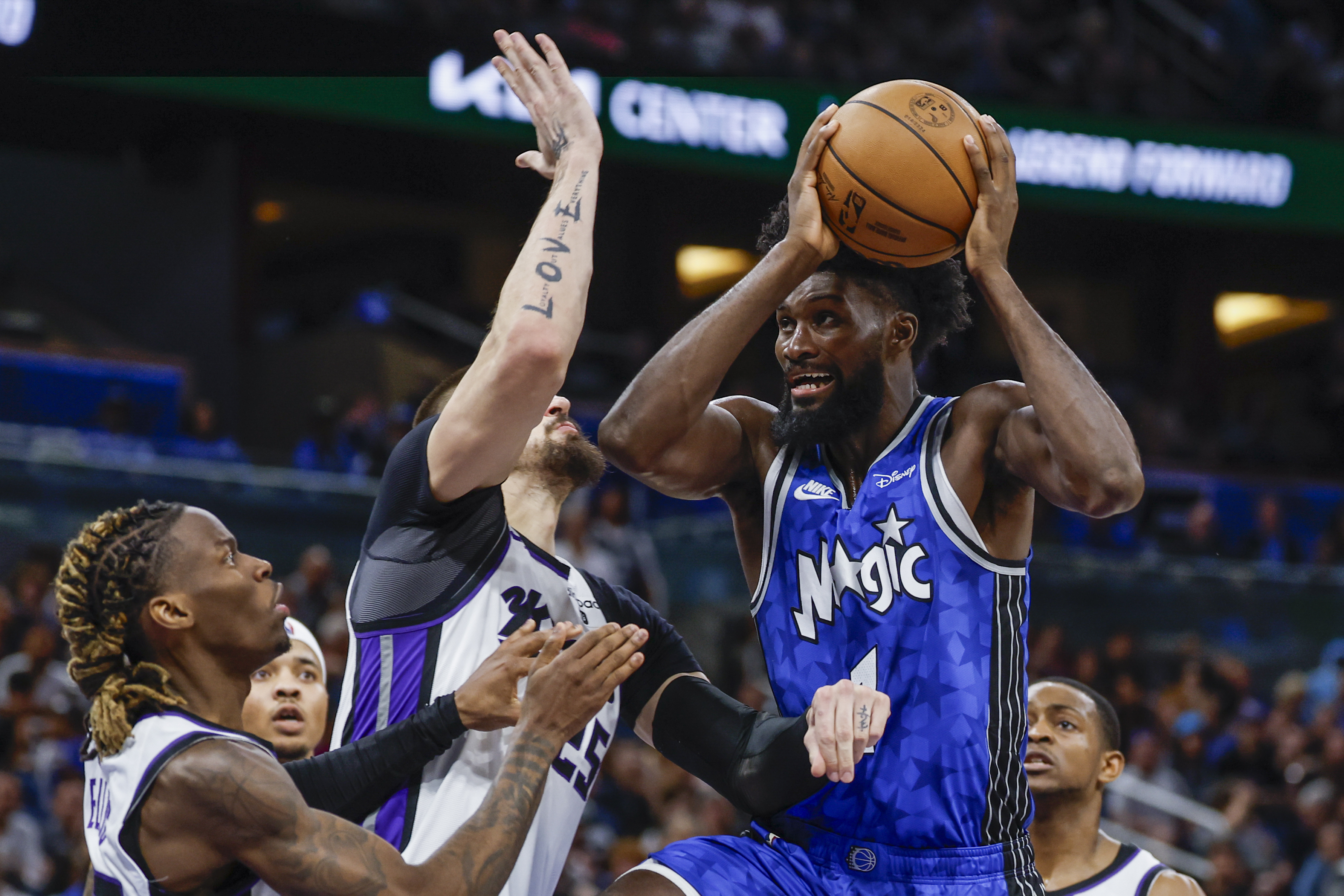 FILE -Orlando Magic forward Jonathan Isaac, right, goes to the basket as he is defended by Sacramento Kings center Alex Len, middle and Sacramento Kings guard Keon Ellis, left, during the second half of an NBA basketball game, Saturday, March 23, 2024, in Orlando, Fla. Jonathan Isaac has agreed to an $84 million deal that will keep him with Orlando for five more seasons, a person with knowledge of the negotiations said Tuesday, July 2, 2024. 