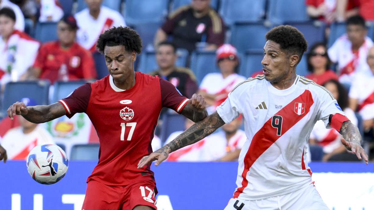 Canada's Tajon Buchanan, 17, and Peru's Paolo Guerrero battle for the ball during a Copa America Group A soccer match in Kansas City, Kan., Tuesday, June 25, 2024.