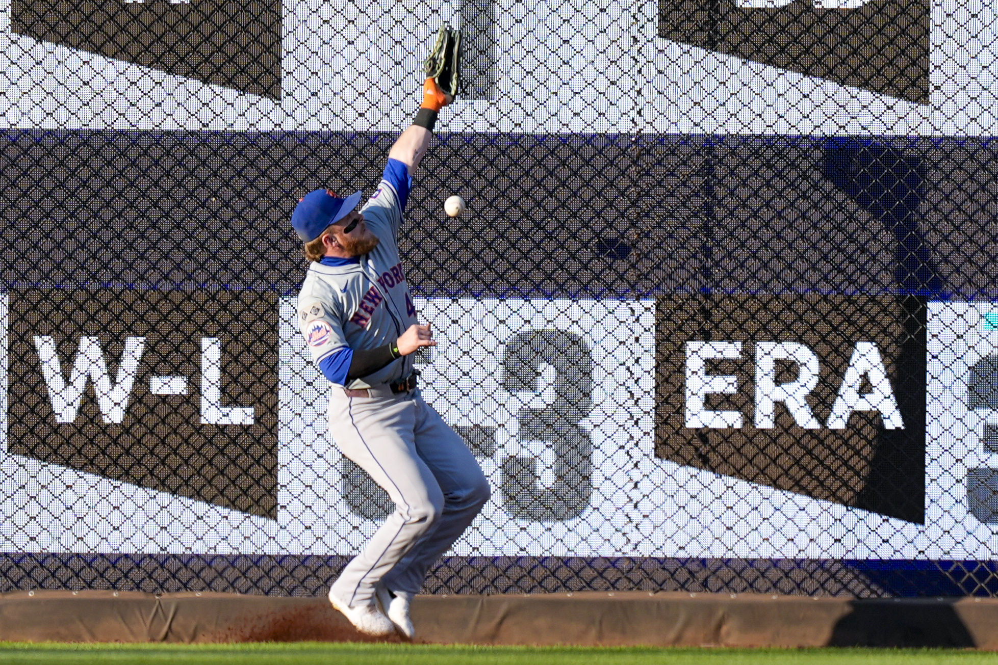 New York Mets center fielder Harrison Bader can't catch a ball hit by Washington Nationals' Jacob Young for a double during the third inning of a baseball game at Nationals Park, Tuesday, July 2, 2024, in Washington. Bader later left the game. 