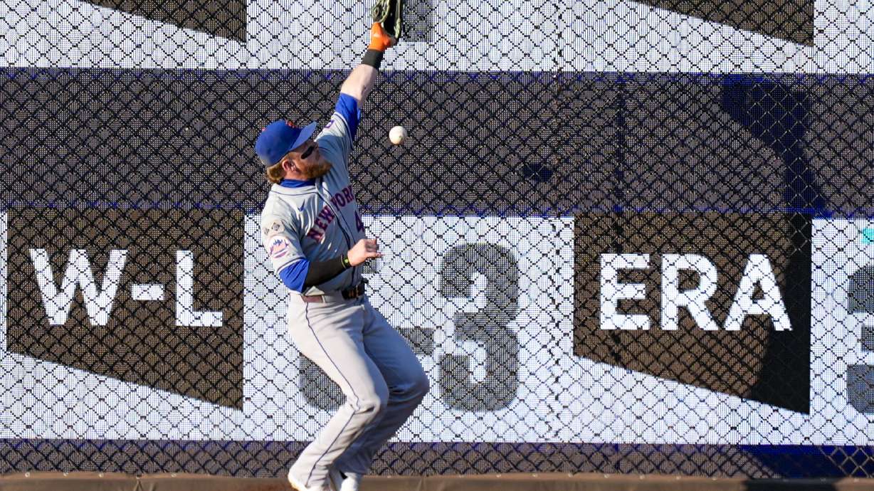 New York Mets center fielder Harrison Bader can't catch a ball hit by Washington Nationals' Jacob Young for a double during the third inning of a baseball game at Nationals Park, Tuesday, July 2, 2024, in Washington. Bader later left the game.