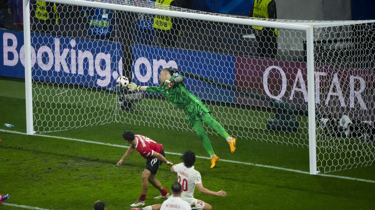 Turkey's goalkeeper Mert Gunok saves the ball during a round of sixteen match between Austria and Turkey at the Euro 2024 soccer tournament in Leipzig, Germany, Tuesday, July 2, 2024.