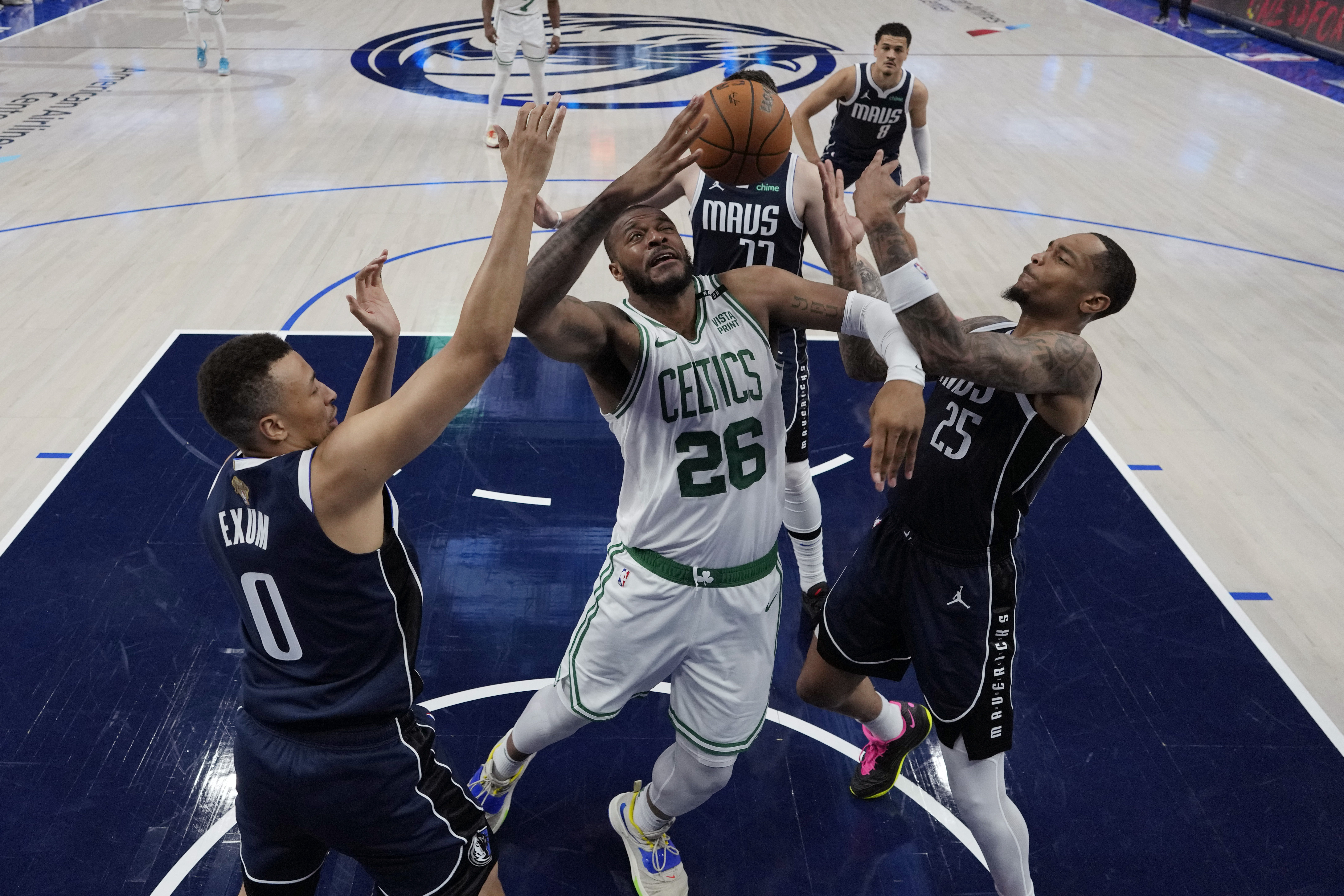 Boston Celtics forward Xavier Tillman (26) battles Dallas Mavericks guard Dante Exum (0) and forward P.J. Washington (25) for a rebound during Game 4 of the NBA basketball finals, Friday, June 14, 2024, in Dallas. 