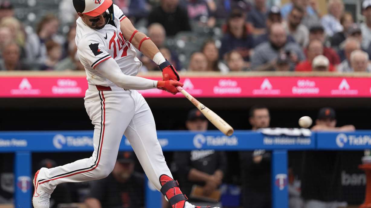 Minnesota Twins' Royce Lewis hits a two-run double during the third inning of a baseball game against the Detroit Tigers, Tuesday, July 2, 2024, in Minneapolis.