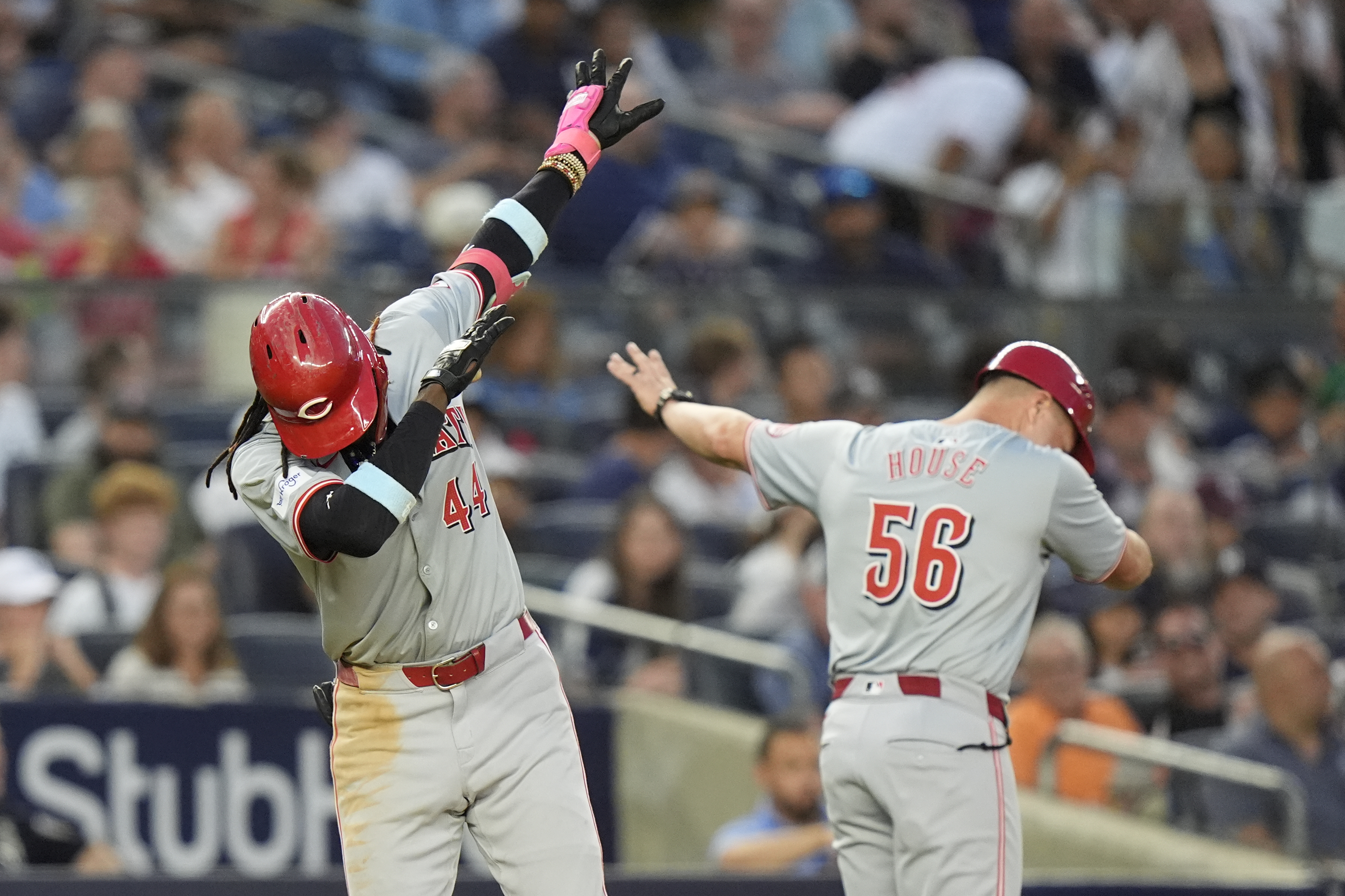 Cincinnati Reds' Elly De La Cruz, left, celebrates with third base coach J.R. House, right, as he runs the bases after hitting a two-run home run during the fifth inning of a baseball gameagainst the New York Yankees, Tuesday, July 2, 2024, in New York. 