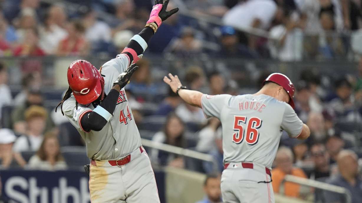 Cincinnati Reds' Elly De La Cruz, left, celebrates with third base coach J.R. House, right, as he runs the bases after hitting a two-run home run during the fifth inning of a baseball gameagainst the New York Yankees, Tuesday, July 2, 2024, in New York.