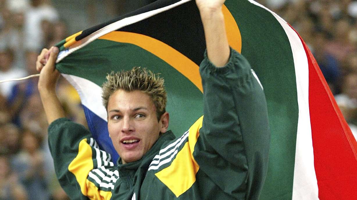 FILE - Jacques Freitag of South Africa waves his national flag after he won the Men's high jump event at the World Athletics Championships, at the Stade de France in Saint Denis, north of Paris, Monday, Aug. 25, 2003. Local media is reporting that South African police have discovered the body of former high jump world champion Jacques Freitag after he went missing last month. The reports said the 42-year-old, who won the 2003 world title in Paris and competed at the 2004 Olympics, had been shot.