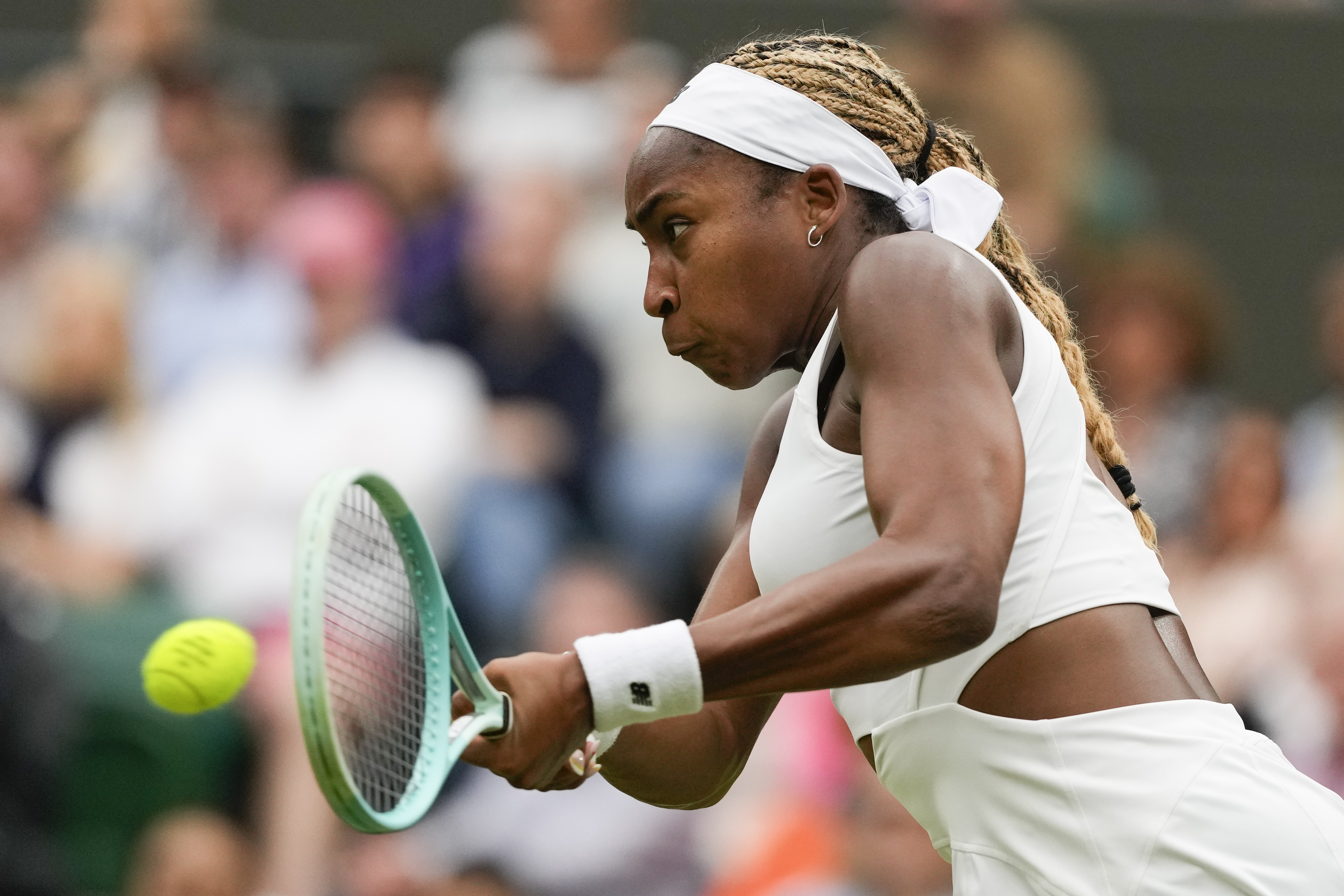 Coco Gauff of the United States plays a backhand return to Anca Todoni of Romania during their match on day three at the Wimbledon tennis championships in London, Wednesday, July 3, 2024.