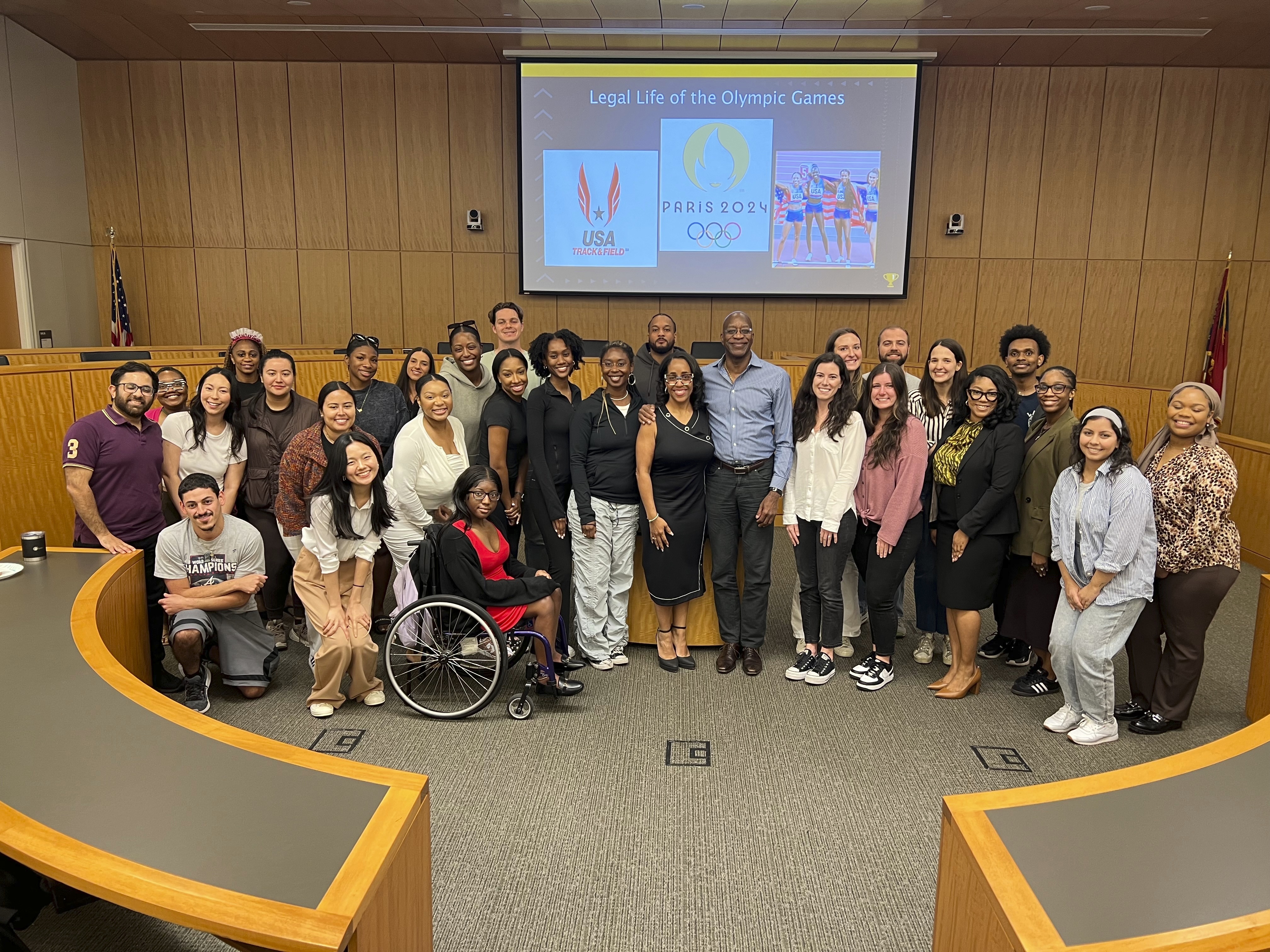 This image released by Georgia State University shows law professor Moraima “Mo” Ivory, center, left, posing with Olympian Edwin Moses, center, right, and her Legal Life class at Georgia State University in Atlanta. Ivory is known for bringing celebrities like Steve Harvey and Ludacris into her law class. But now she's taking her Atlanta law students on a free trip to the Paris Olympics this summer in hopes of creating real-life teachable moments. 