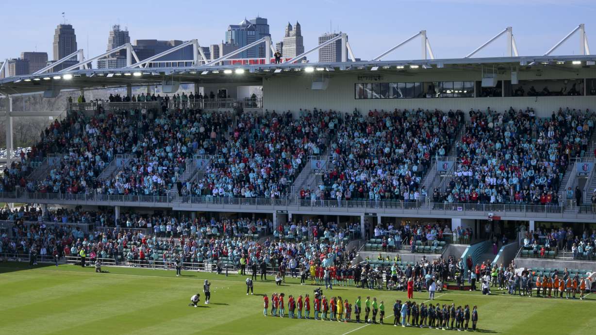 FILE - With the skyline of Kansas City behind them, both teams line up before the start of an NWSL soccer match between the Kansas City Current and the Portland Thorns FC at the new CPKC Stadium, Saturday, March 16, 2024, in Kansas City, Mo. The championship game of the National Women's Soccer League will be played Nov. 23 at CPKC Stadium, the home of the Kansas City Current and one of the first purpose-built stadiums for a professional women's team in the world. The league made the announcement Wednesday, July 3, 2024.