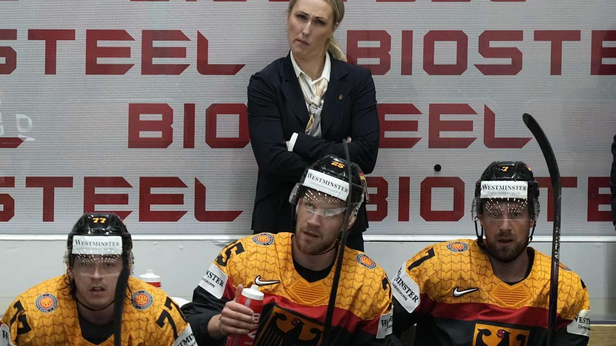 FILE - Germany's assistant coach Jessica Campbell stands behind players at the German bench during the group A Hockey World Championship match between France and Germany in Helsinki, Finland, Monday May 16, 2022. Jessica Campbell will become the first woman to work on the bench of an NHL franchise after the Seattle Kraken hired her as an assistant coach Wednesday, July 3, 2024.