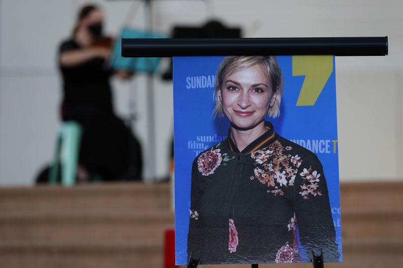 A musician plays a violin behind a photograph of cinematographer Halyna Hutchins during a vigil in her honor in Albuquerque, N.M.,  Oct. 23, 2021.