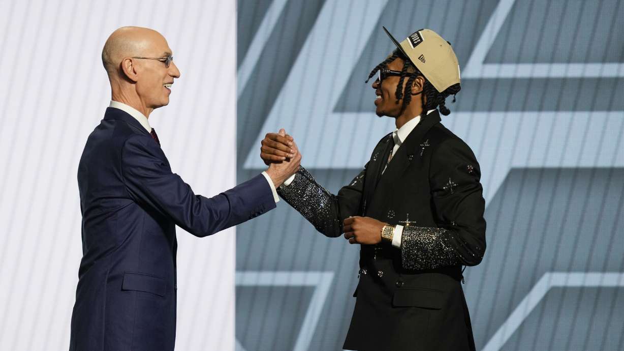 Rob Dillingham, right, greets NBA commissioner Adam Silver after being selected by the San Antonio Spurs during the first round of the NBA basketball draft, Wednesday, June 26, 2024, in New York.