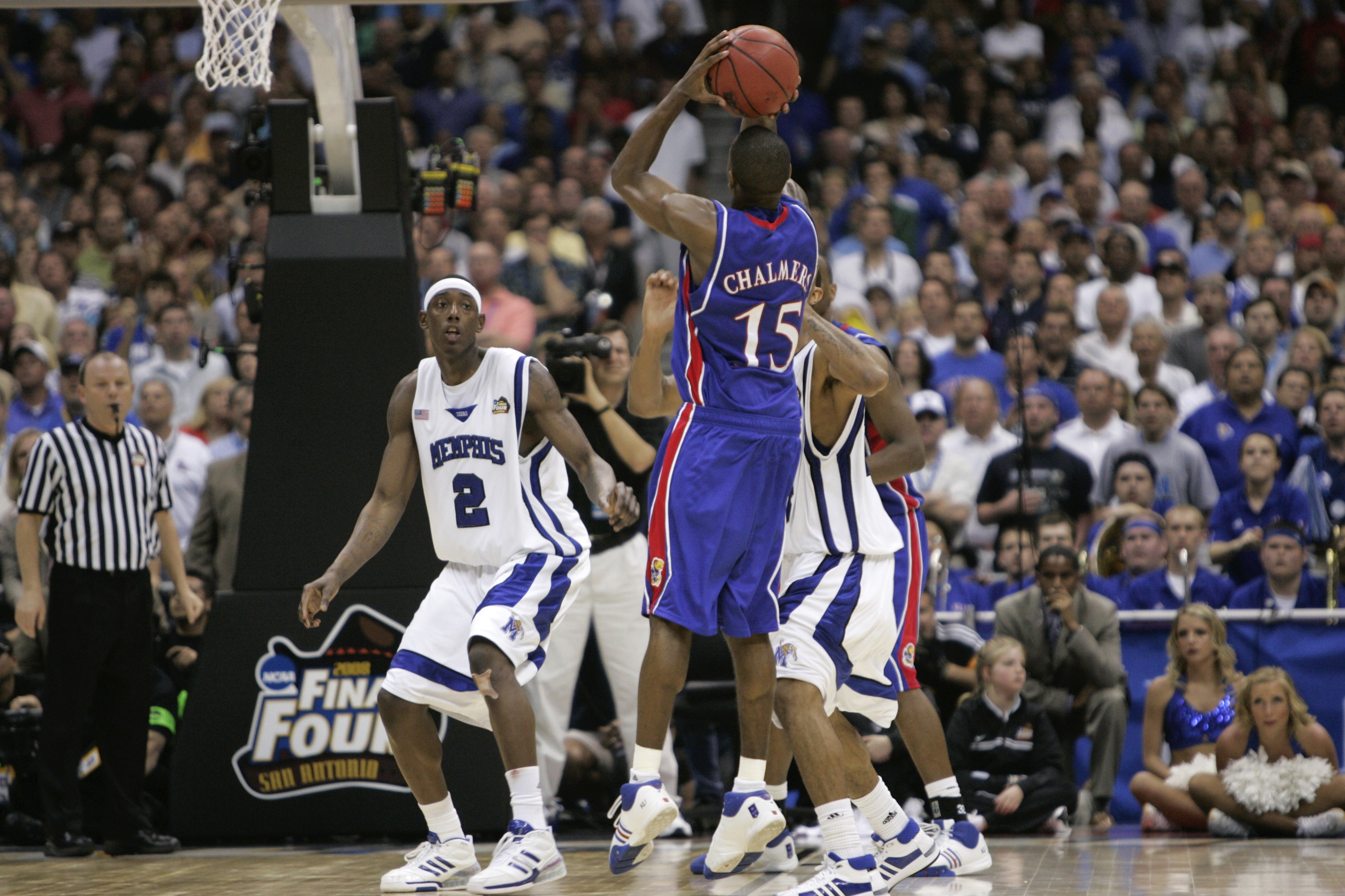 FILE - In this Monday, April 7, 2008, file photo, Kansas' Mario Chalmers shoots a 3-pointer to take the game in to overtime against Memphis during the championship game at the NCAA college basketball Final Four in San Antonio. Kansas stars Mario Chalmers and Sherron Collins are among 16 former men’s college basketball players who have sued the NCAA and multiple conferences, claiming they are profiting from the unauthorized use of their names, images and likenesses in promoting and monetizing the March Madness tournament. 
