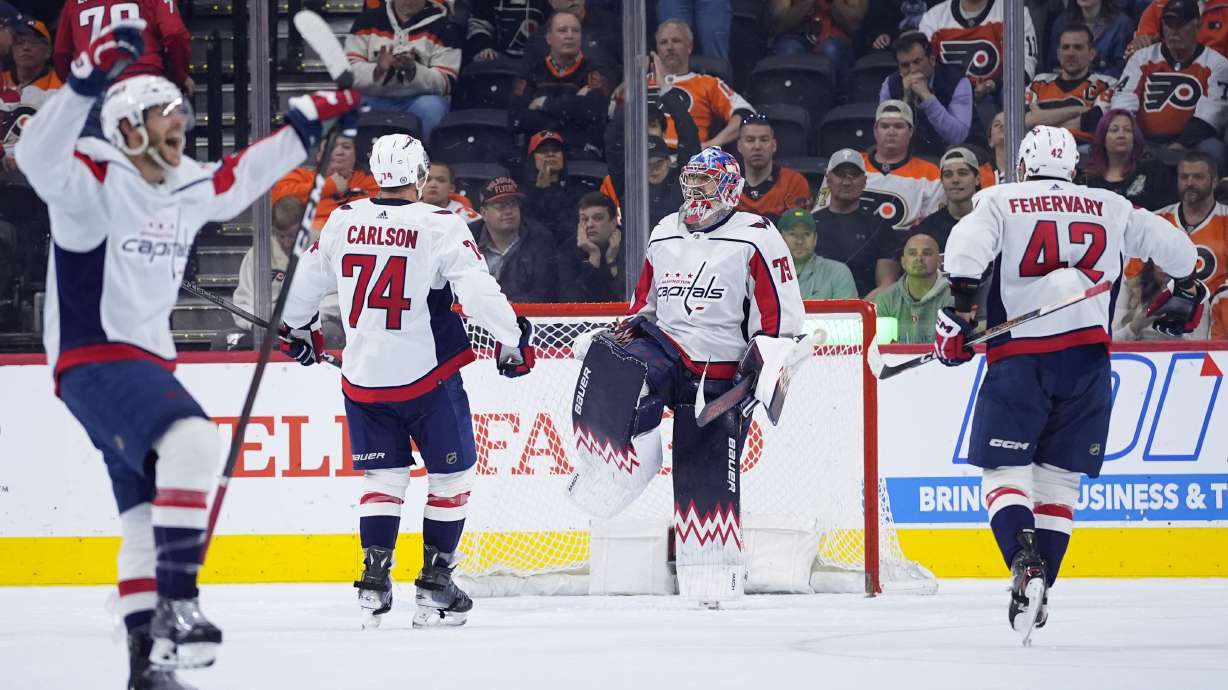 FILE - Washington Capitals' Charlie Lindgren (79) celebrates with Martin Fehervary (42) and John Carlson (74) after the Capitals won an NHL hockey game against the Philadelphia Flyers, Tuesday, April 16, 2024, in Philadelphia. So much for just trying to get Alex Ovechkin to break Wayne Gretzky’s NHL career goals record. The Washington Capitals are going all in to keep their contending window open.