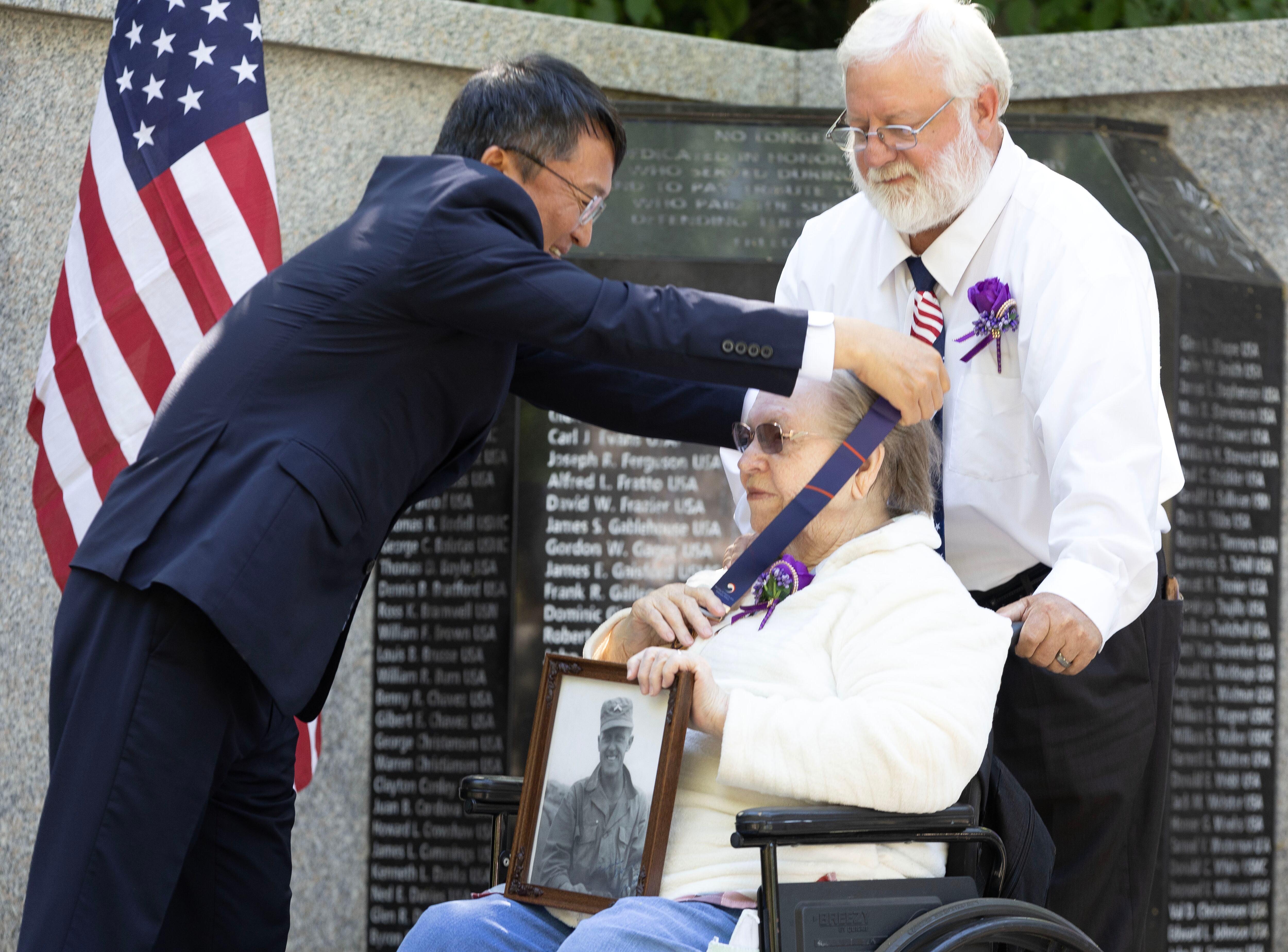 Lim Jung-taek, consul general of Korea, presents an Ambassador for Peace Medal to Joyce Davis and her son, Cole Davis, on behalf of Joyce’s husband and Korean War veteran Denis Davis during a ceremony at the Korean War Memorial in Memory Grove Park in Salt Lake City on Wednesday.
