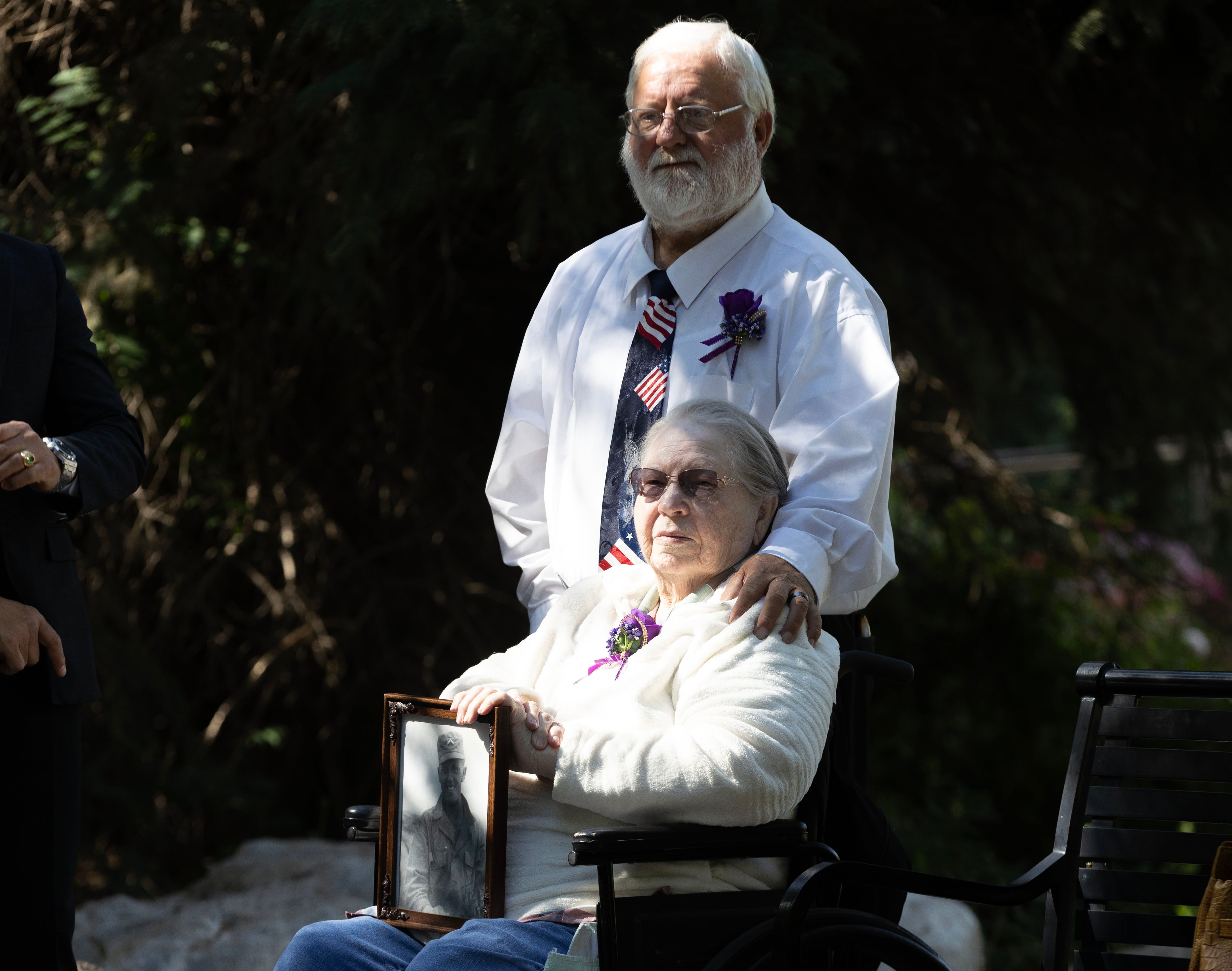 Joyce Davis holds a framed portrait of her Korean War veteran husband Denis Davis, while her son, Cole Davis, puts a hand on her shoulder during a ceremony at the Korean War Memorial in Memory Grove Park, where Lim Jung-taek, consul general of Korea, presented Korean War veterans with Ambassador for Peace Medals in Salt Lake City on Wednesday.