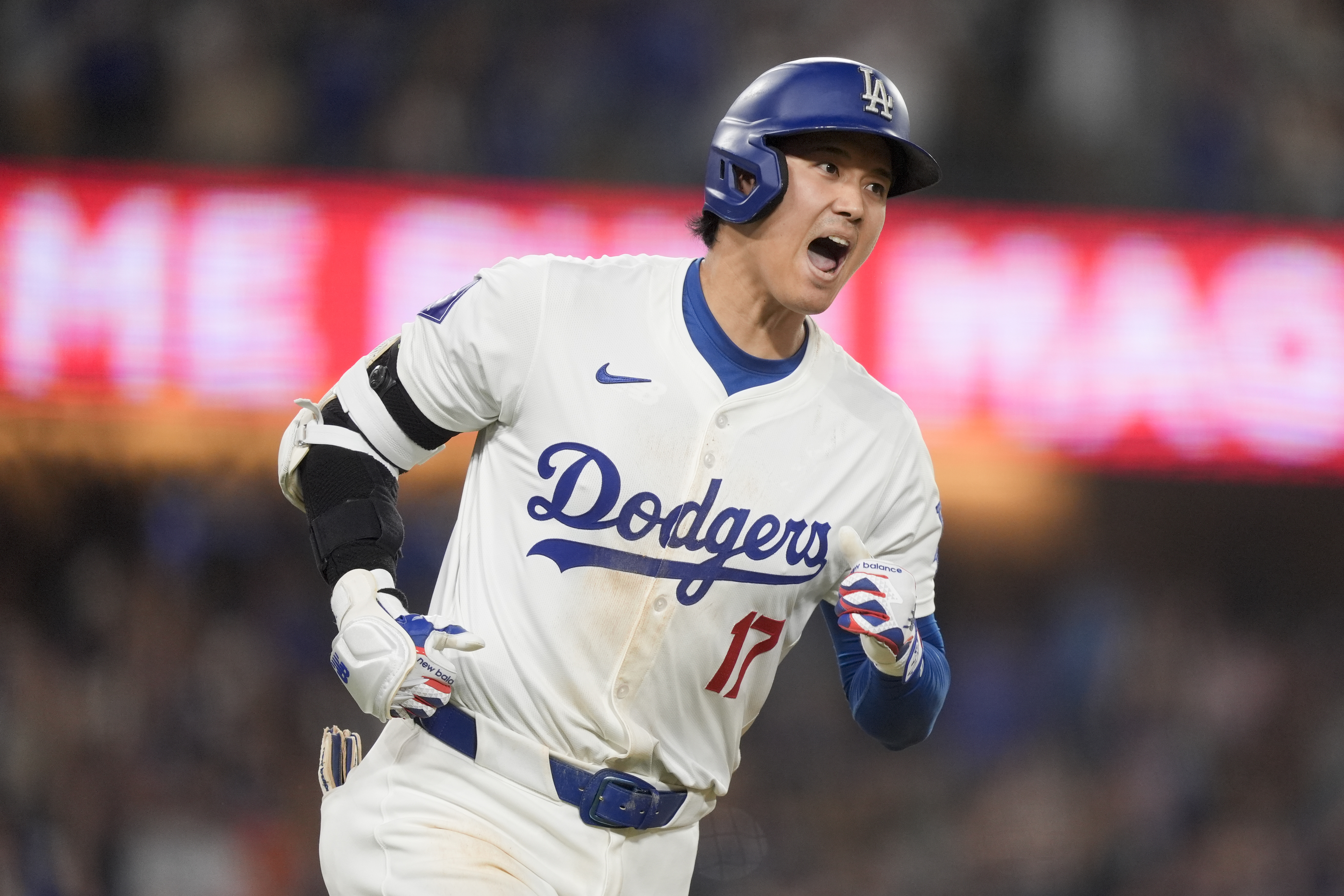 Los Angeles Dodgers designated hitter Shohei Ohtani celebrates his go-ahead two-run home run during the seventh inning of a baseball game against the Arizona Diamondbacks, Tuesday, July 2, 2024, in Los Angeles. 