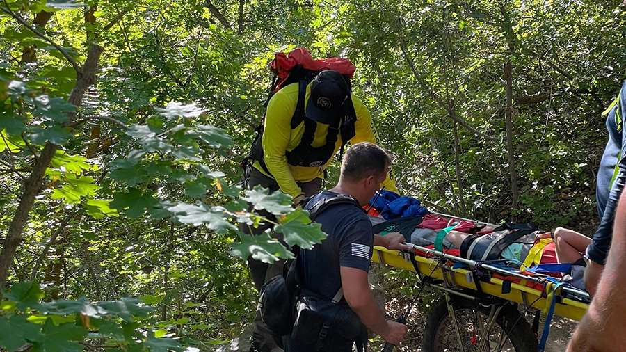 Search and rescue crews carry a treasure hunter who needed to be carried out of the Beus Canyon trail after hurting their ankle.