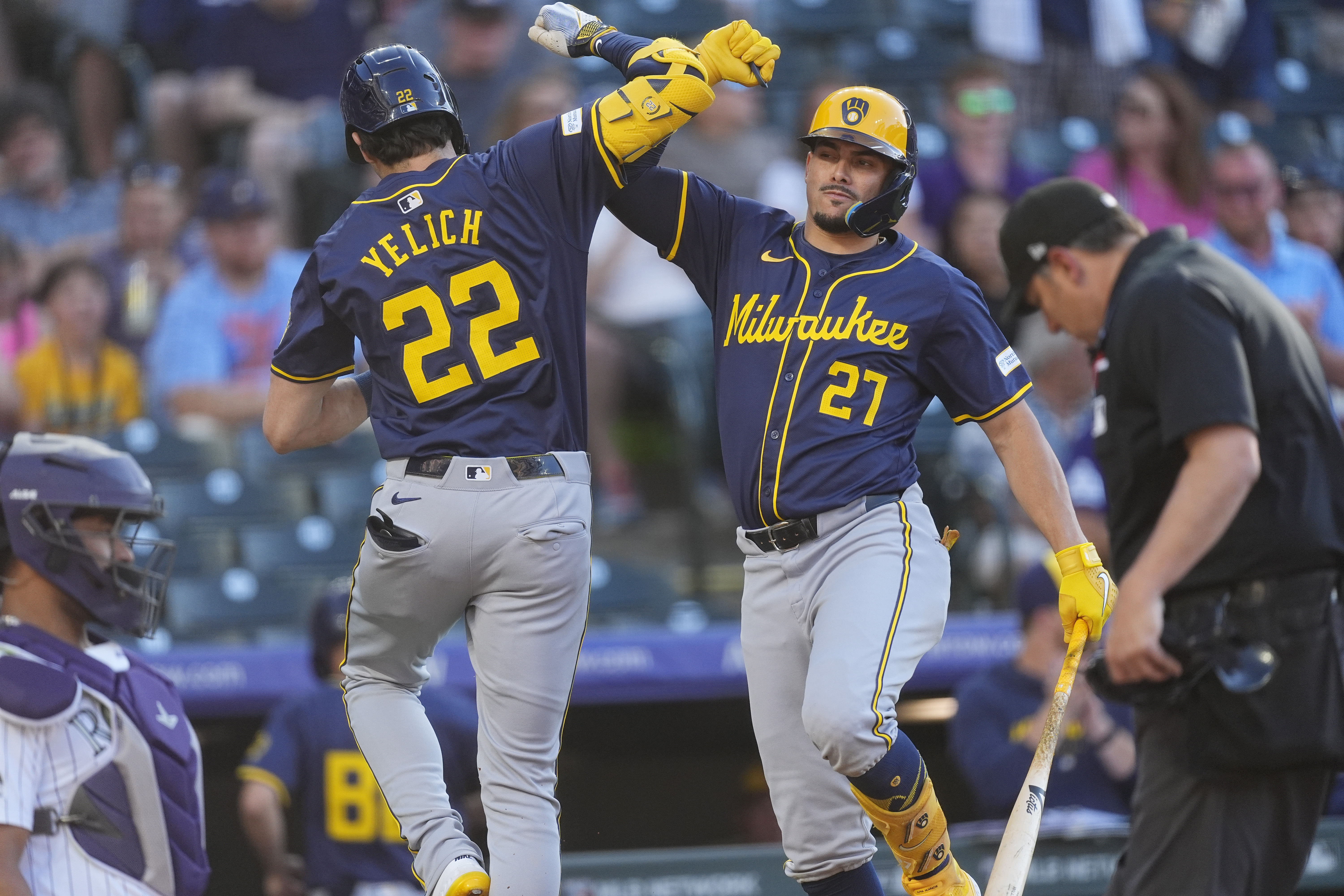 Milwaukee Brewers' Willy Adames, right, congratulates Christian Yelich after his solo home run off Colorado Rockies starting pitcher Dakota Hudson in the first inning of a baseball game, Wednesday, July 3, 2024, in Denver. 