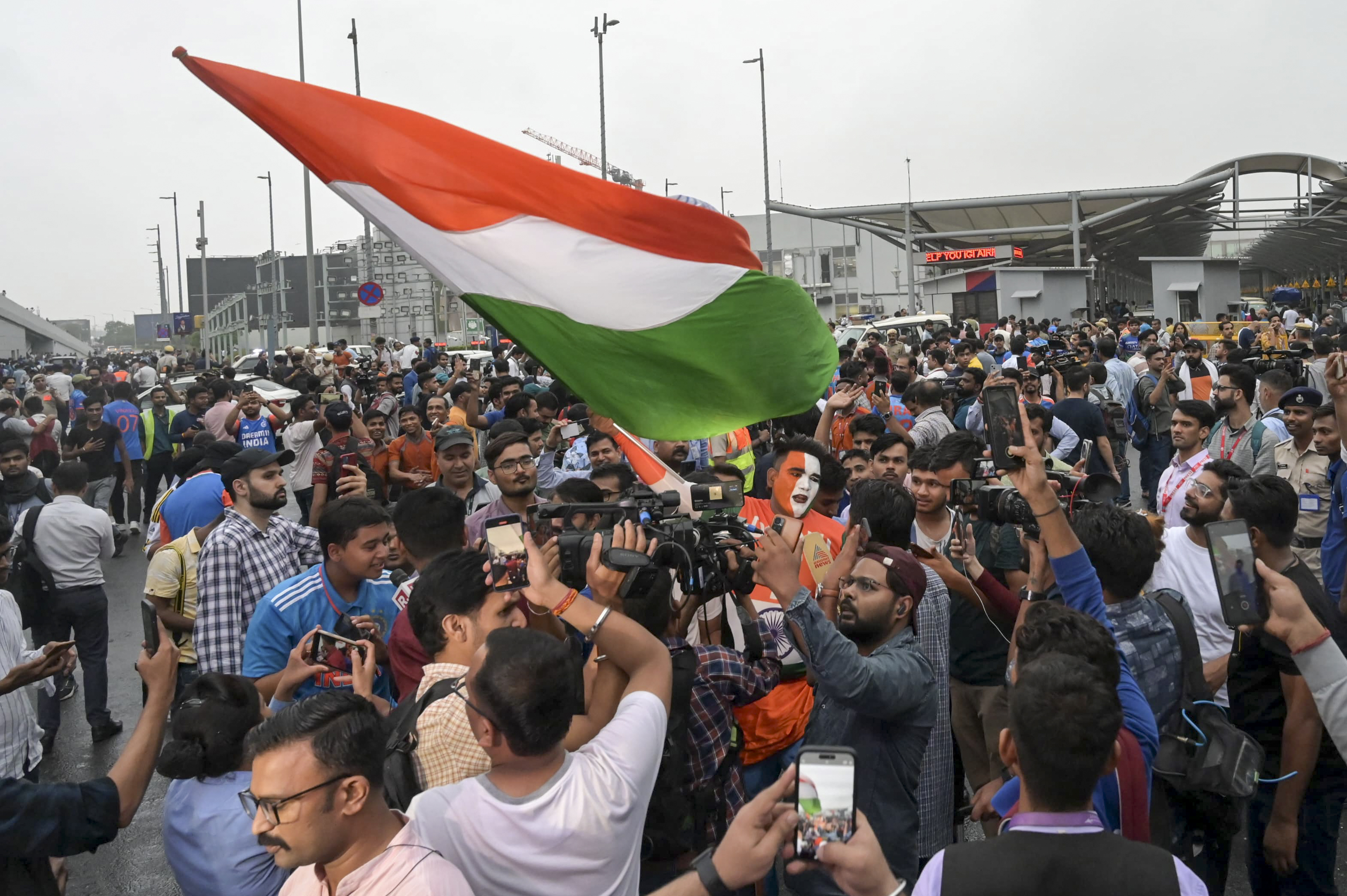 Fans gather outside the Indira Gandhi International Airport to get a glimpse of the Indian cricket players before they returned Thursday after winning the T20 Cricket World Cup, in New Delhi, India, Thursday, July 4, 2024. 