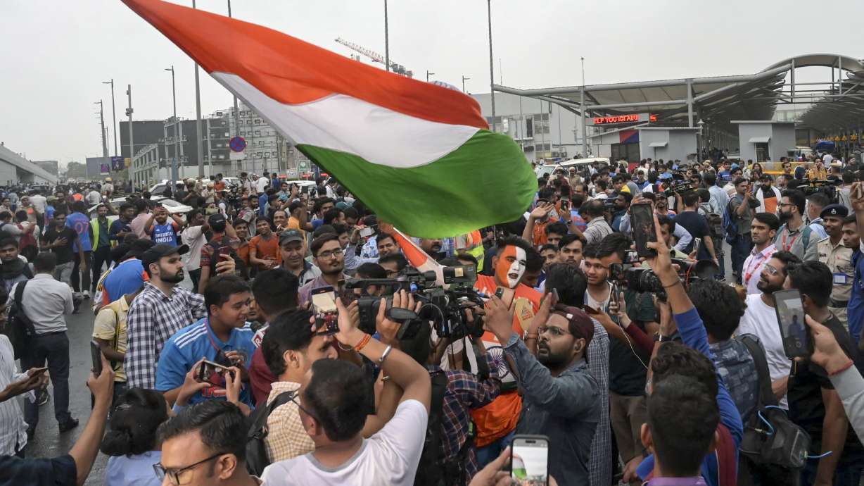 Fans gather outside the Indira Gandhi International Airport to get a glimpse of the Indian cricket players before they returned Thursday after winning the T20 Cricket World Cup, in New Delhi, India, Thursday, July 4, 2024.