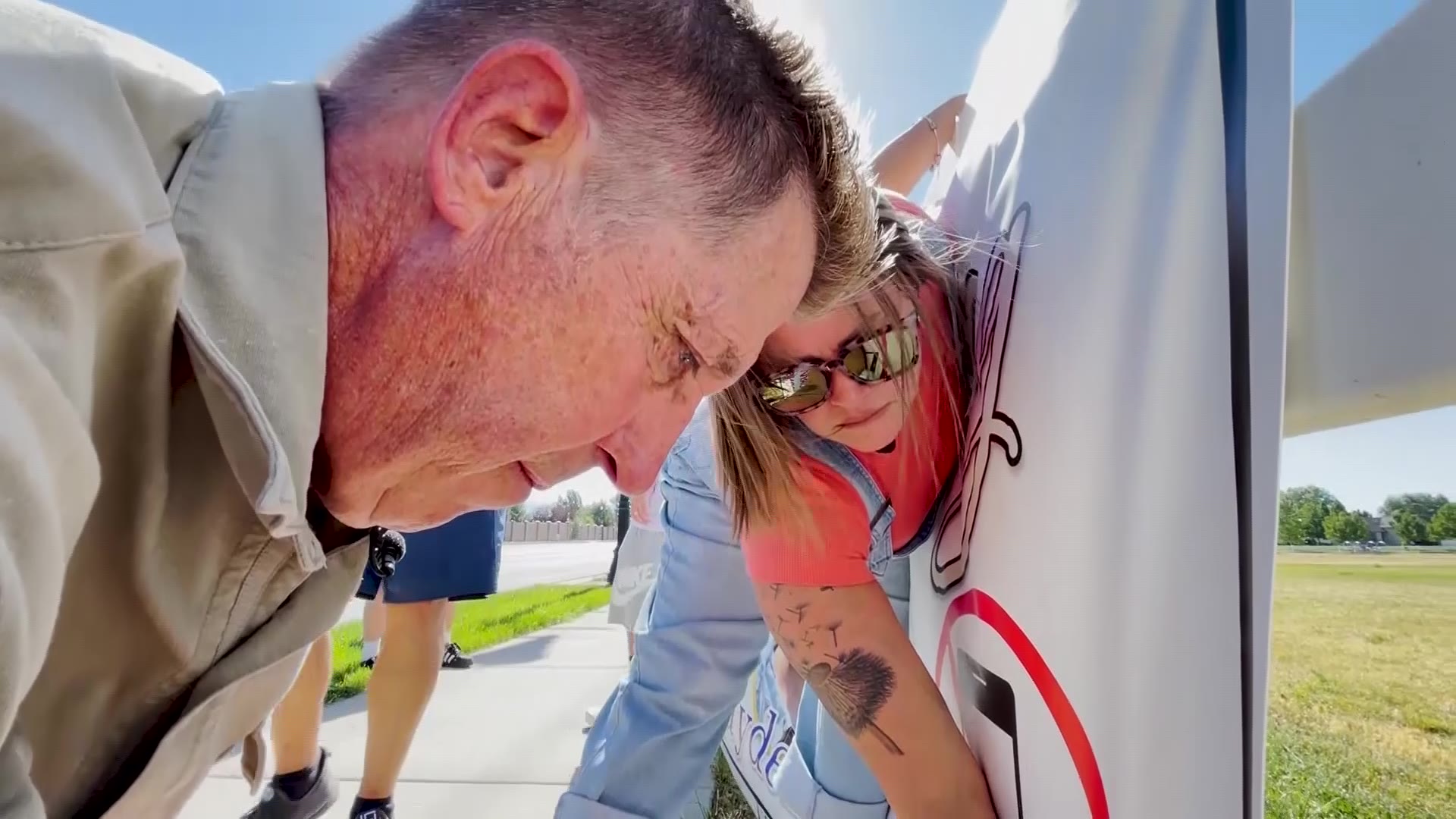 Clark Monk and Jamie Beach hang up a poster advocating against distracted driving in memory of Brayden Long, who died in 2022.