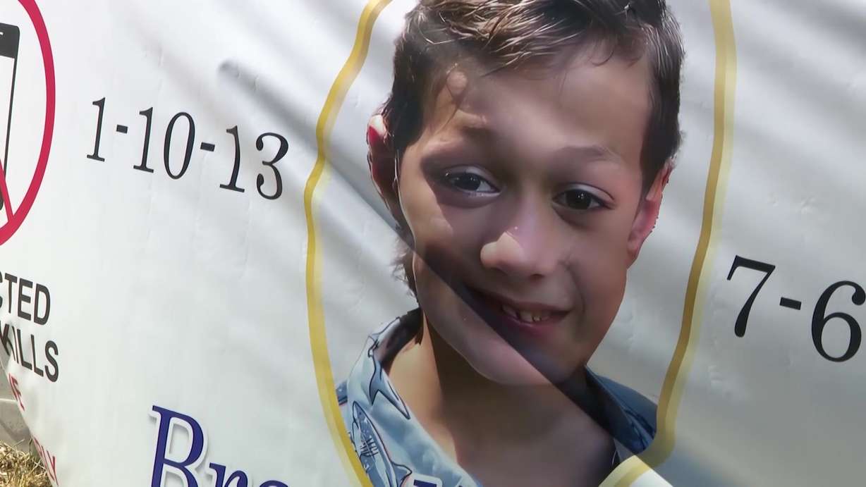 Family members hung a poster advocating against distracted driving in memory of Brayden Long, who died in 2022, at the site of the accident.