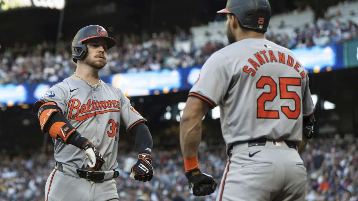 Baltimore Orioles' Ryan O'Hearn celebrates with Anthony Santander after hitting a solo home run during the fifth inning of a baseball game against the Seattle Mariners, Wednesday, July 3, 2024, in Seattle.