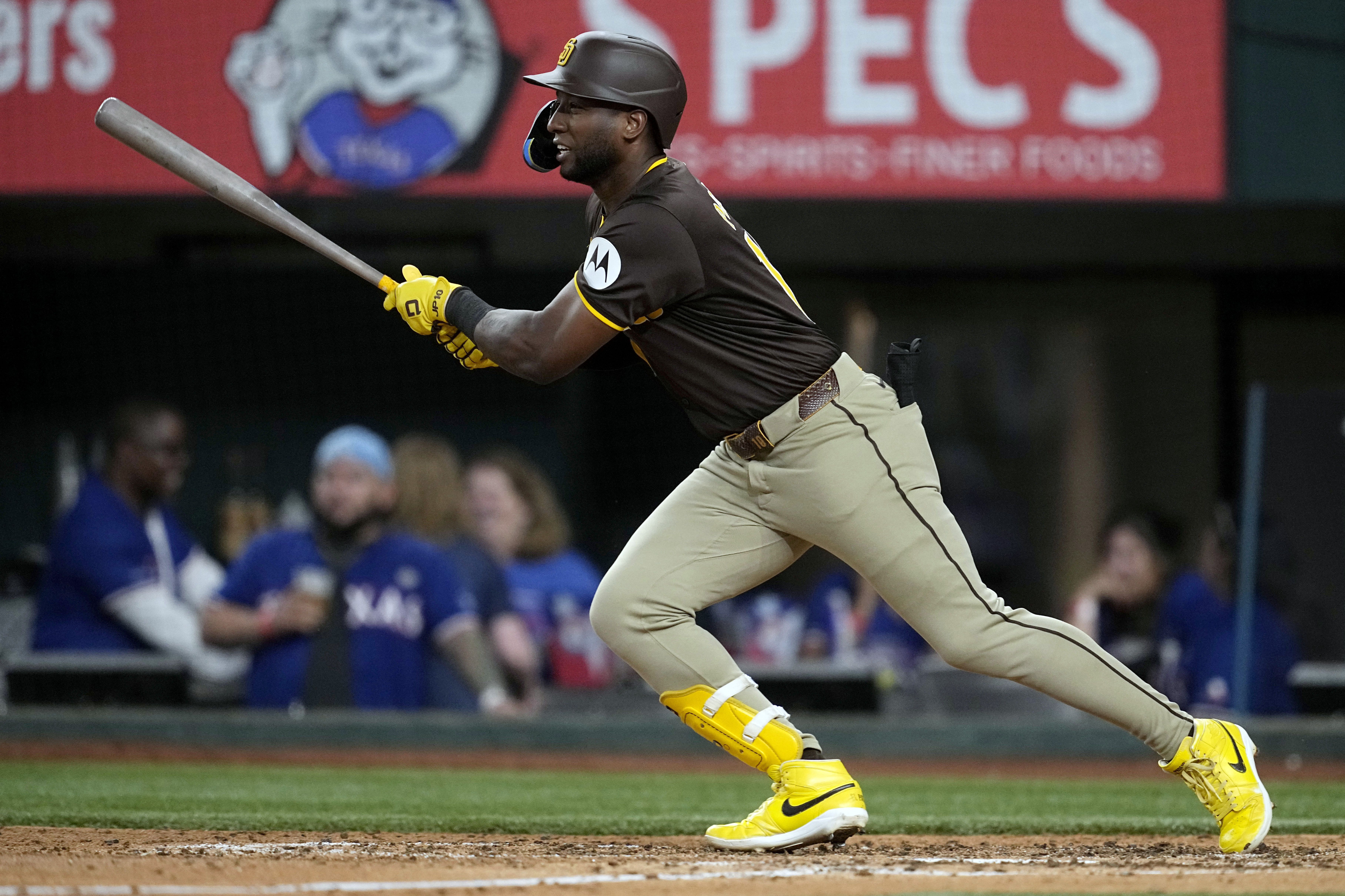 San Diego Padres' Jurickson Profar follows through on a single against the Texas Rangers in the fifth inning of a baseball game Wednesday, July 3, 2024 in Arlington, Texas. 