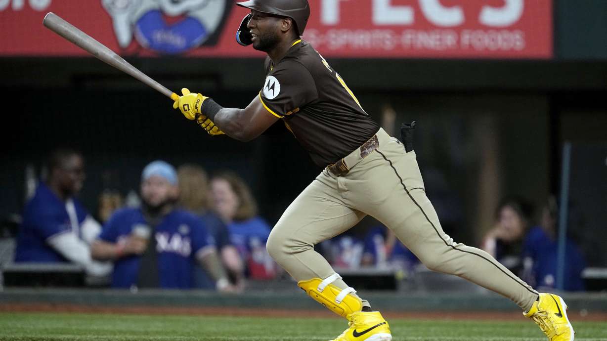 San Diego Padres' Jurickson Profar follows through on a single against the Texas Rangers in the fifth inning of a baseball game Wednesday, July 3, 2024 in Arlington, Texas.