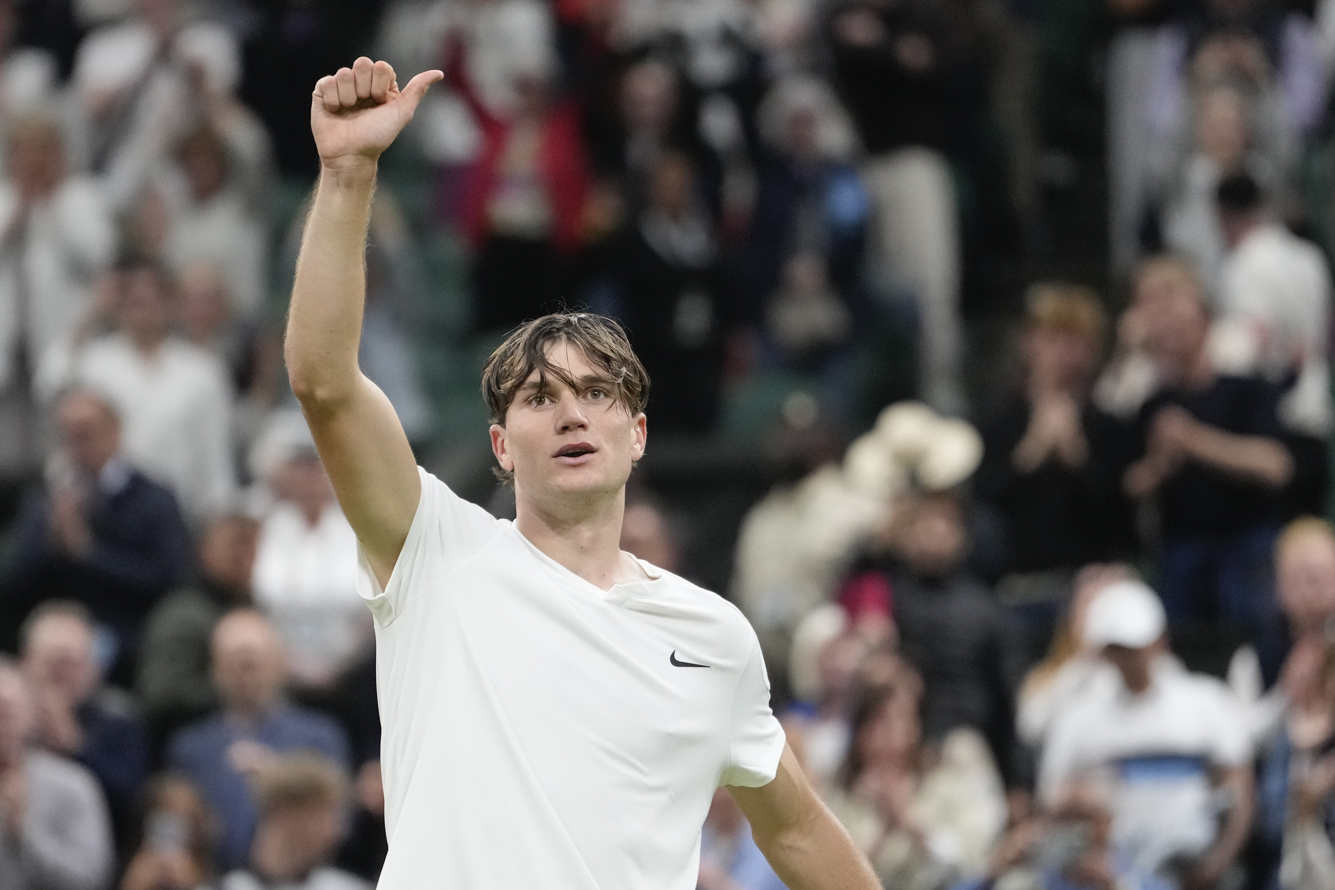 Jack Draper of Britain celebrates after defeating Elias Ymer of Sweden in their first round match at the Wimbledon tennis championships in London, Tuesday, July 2, 2024. 