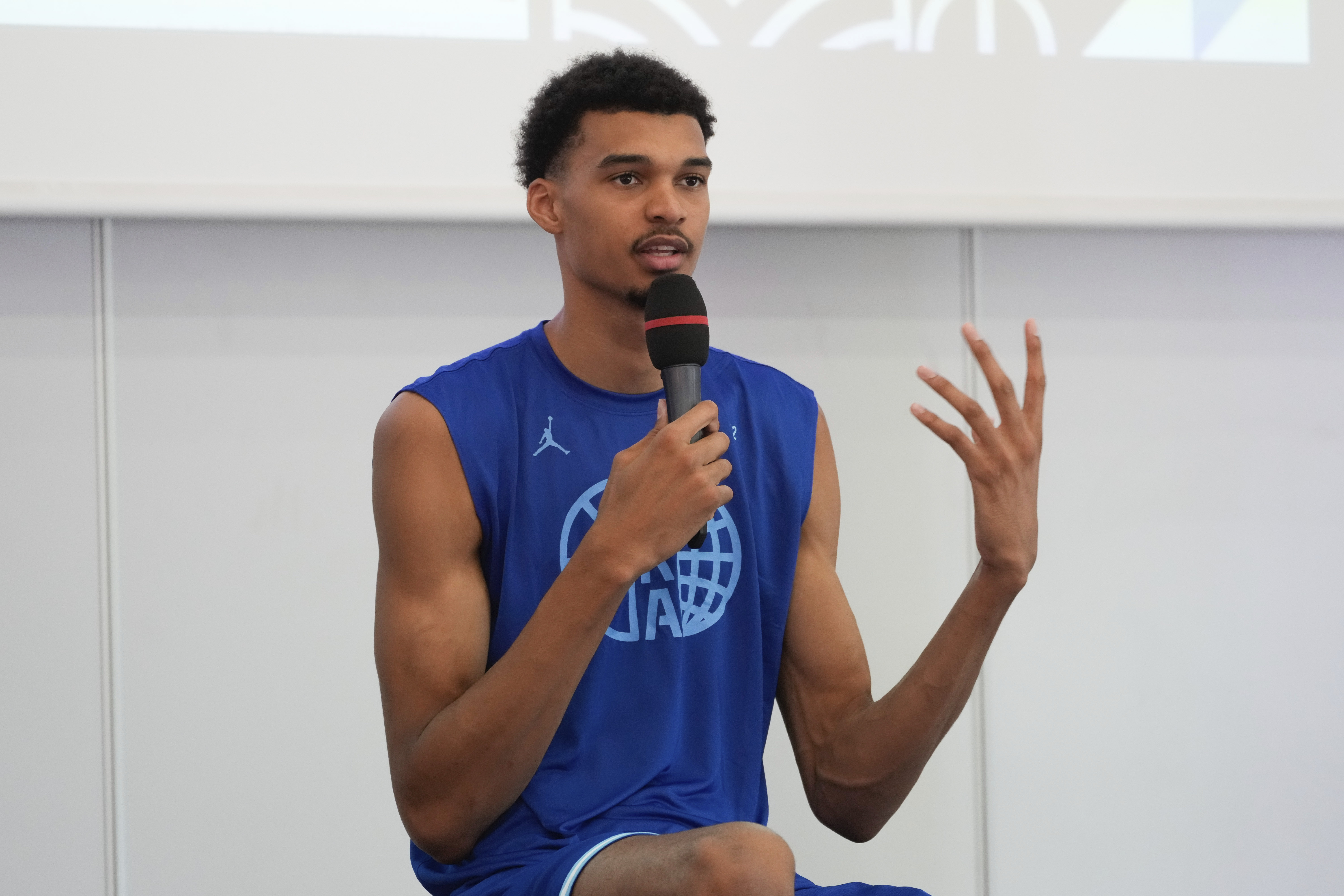 France's basketball player Victor Wembanyama, who plays for the NBA San Antonio Spurs, gestures while speaking during media day at the French National Institute of Sport and Physical Education, in Vincennes, outside Paris, Thursday, June 27, 2024.