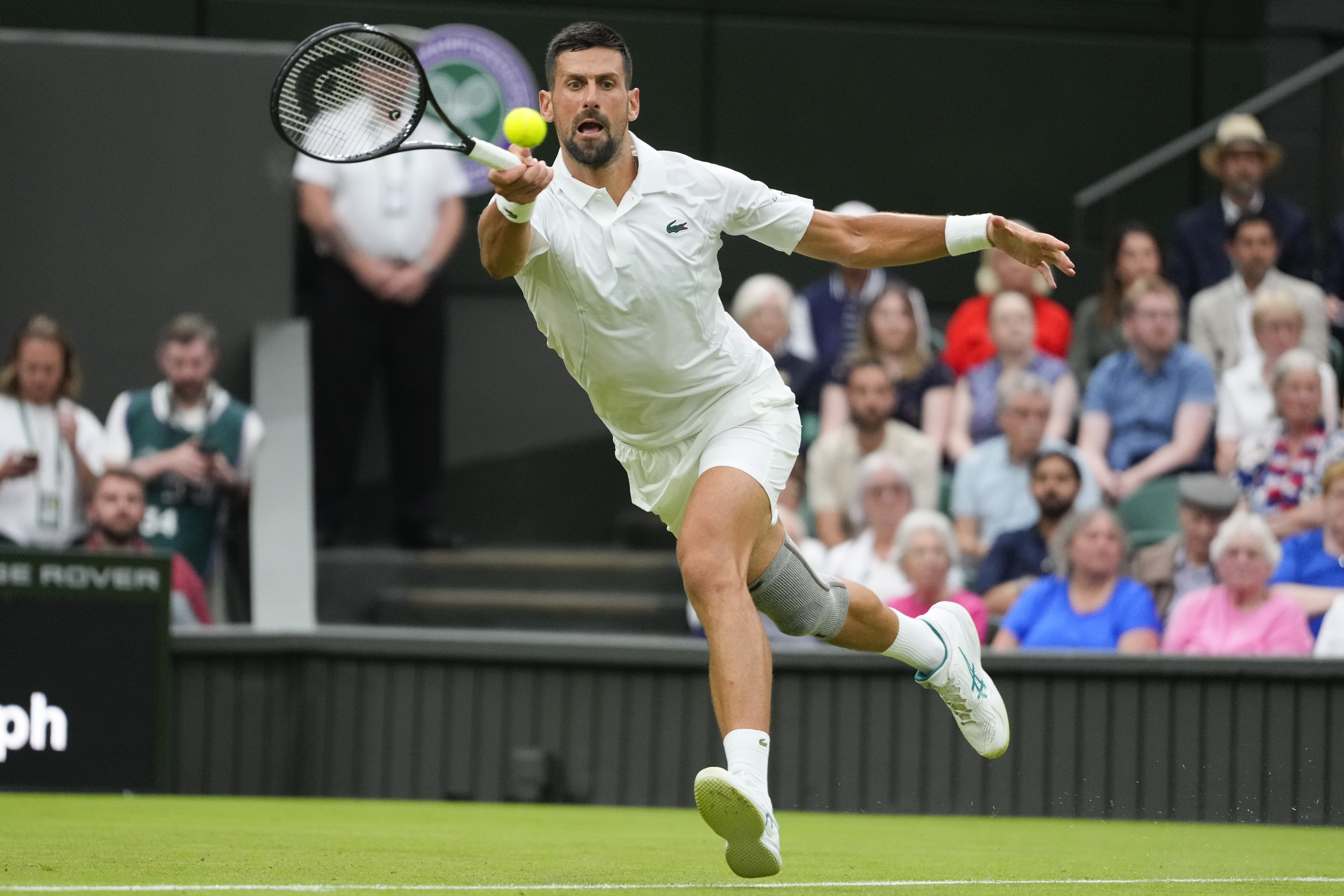 Serbia's Novak Djokovic plays a forehand return to Vit Kopriva of the Czech Republic during their first round match at the Wimbledon tennis championships in London, Tuesday, July 2, 2024. 