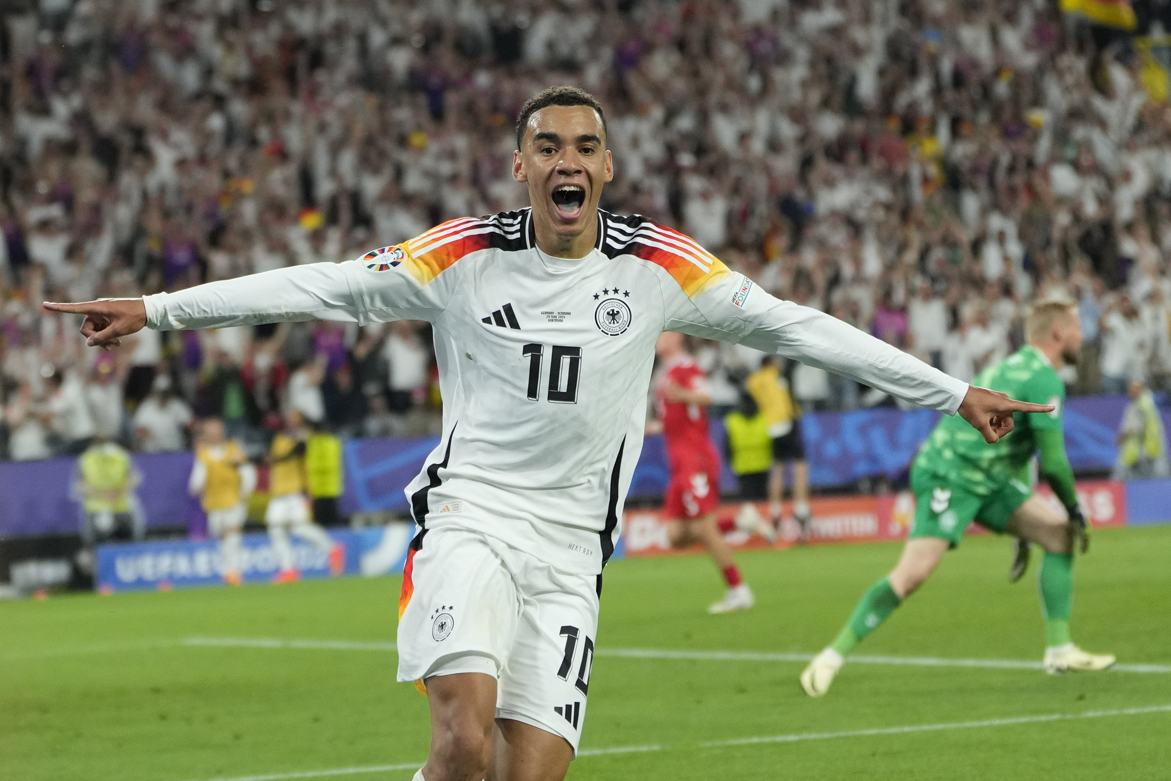 Germany's Jamal Musiala celebrates after scoring his side's second goal during a round of sixteen match between Germany and Denmark at the Euro 2024 soccer tournament in Dortmund, Germany, Saturday, June 29, 2024. 