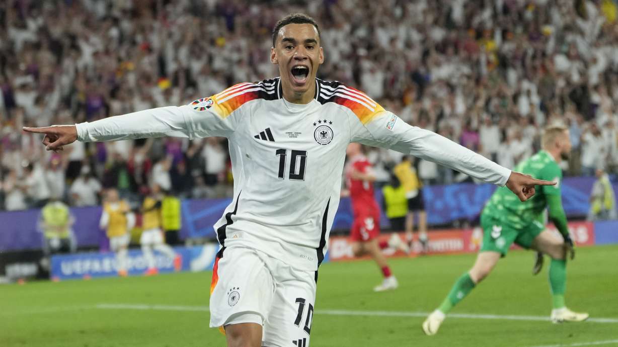 Germany's Jamal Musiala celebrates after scoring his side's second goal during a round of sixteen match between Germany and Denmark at the Euro 2024 soccer tournament in Dortmund, Germany, Saturday, June 29, 2024.