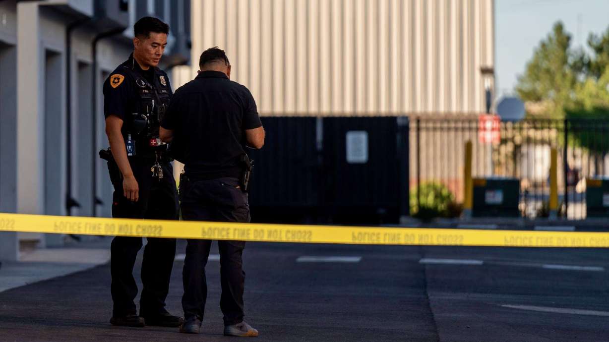 Two Salt Lake police officers secure the scene of a shooting at 385 W. 1700 South on Thursday.