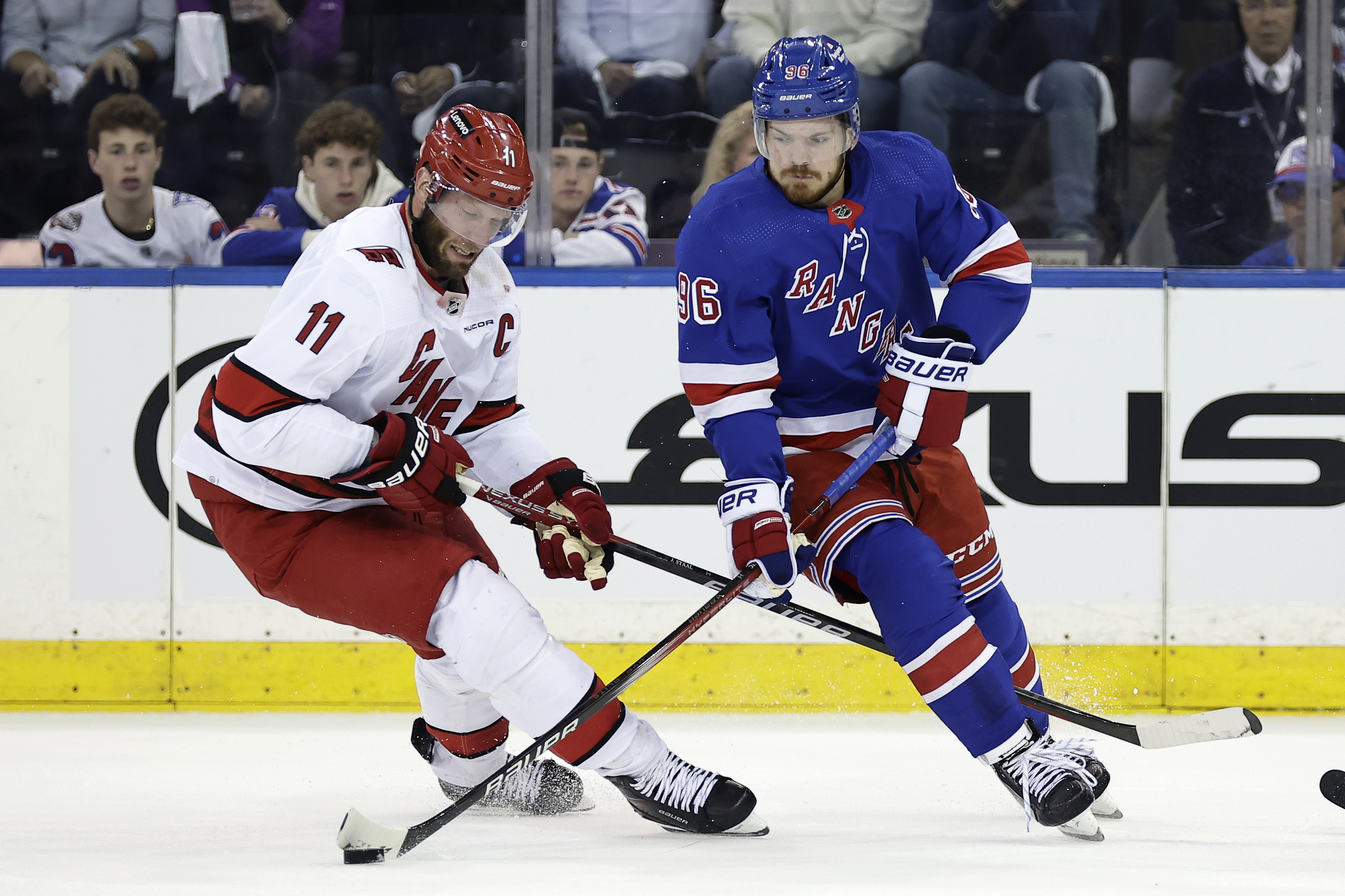FILE -New York Rangers center Jack Roslovic (96) skates with the puck past Carolina Hurricanes center Jordan Staal in the first period during Game 5 of an NHL hockey Stanley Cup second-round playoff series, Monday, May 13, 2024, in New York. The Carolina Hurricanes continued to restock in free agency by signing forward Jack Roslovic to a one-year contract worth $2.8 million. He is the sixth different NHL player the Hurricanes have added this week.