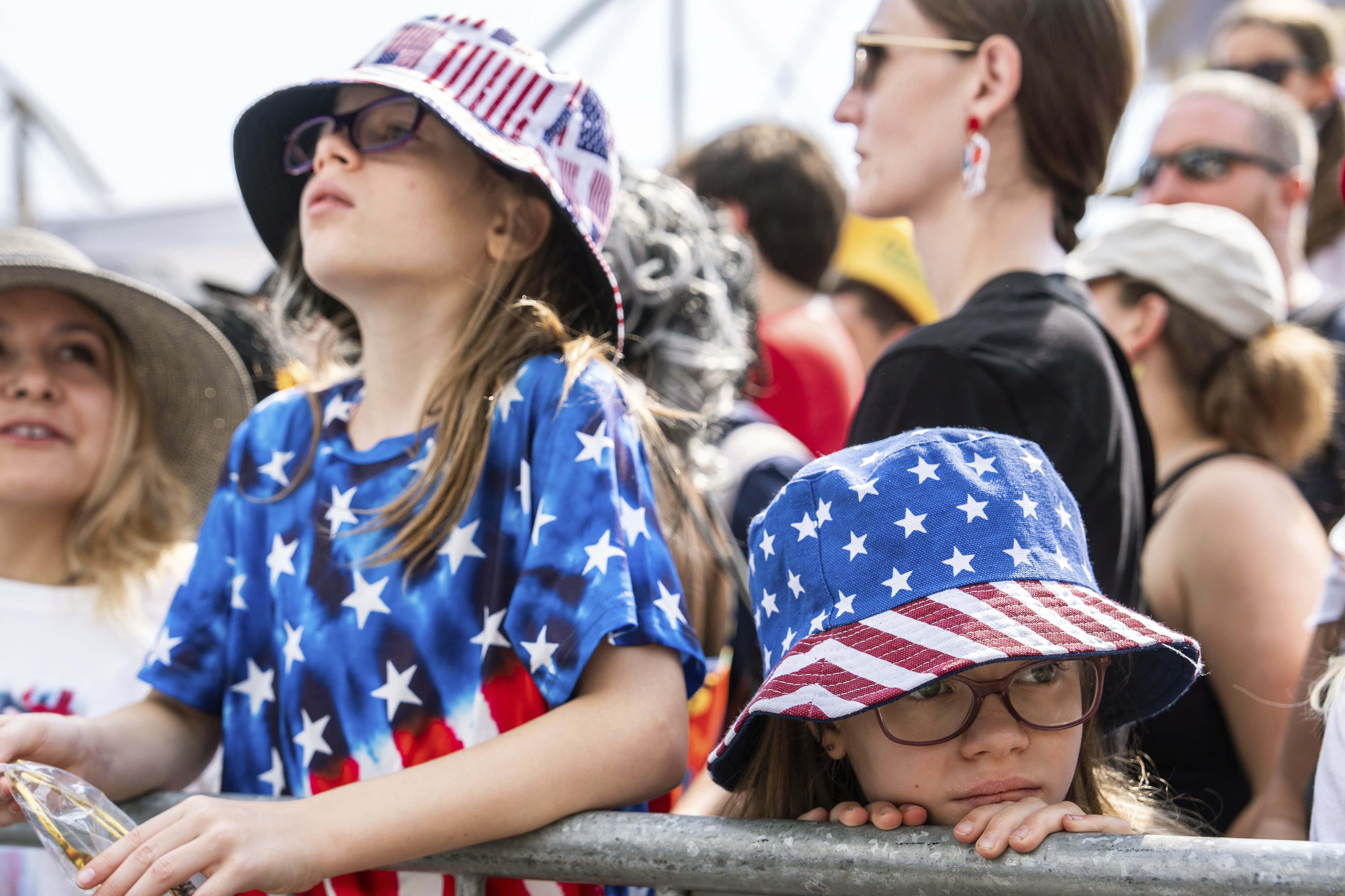 People wait for the Nathan's Famous Fourth of July hot dog eating contest to start, Thursday, at Coney Island in the Brooklyn borough of New York.