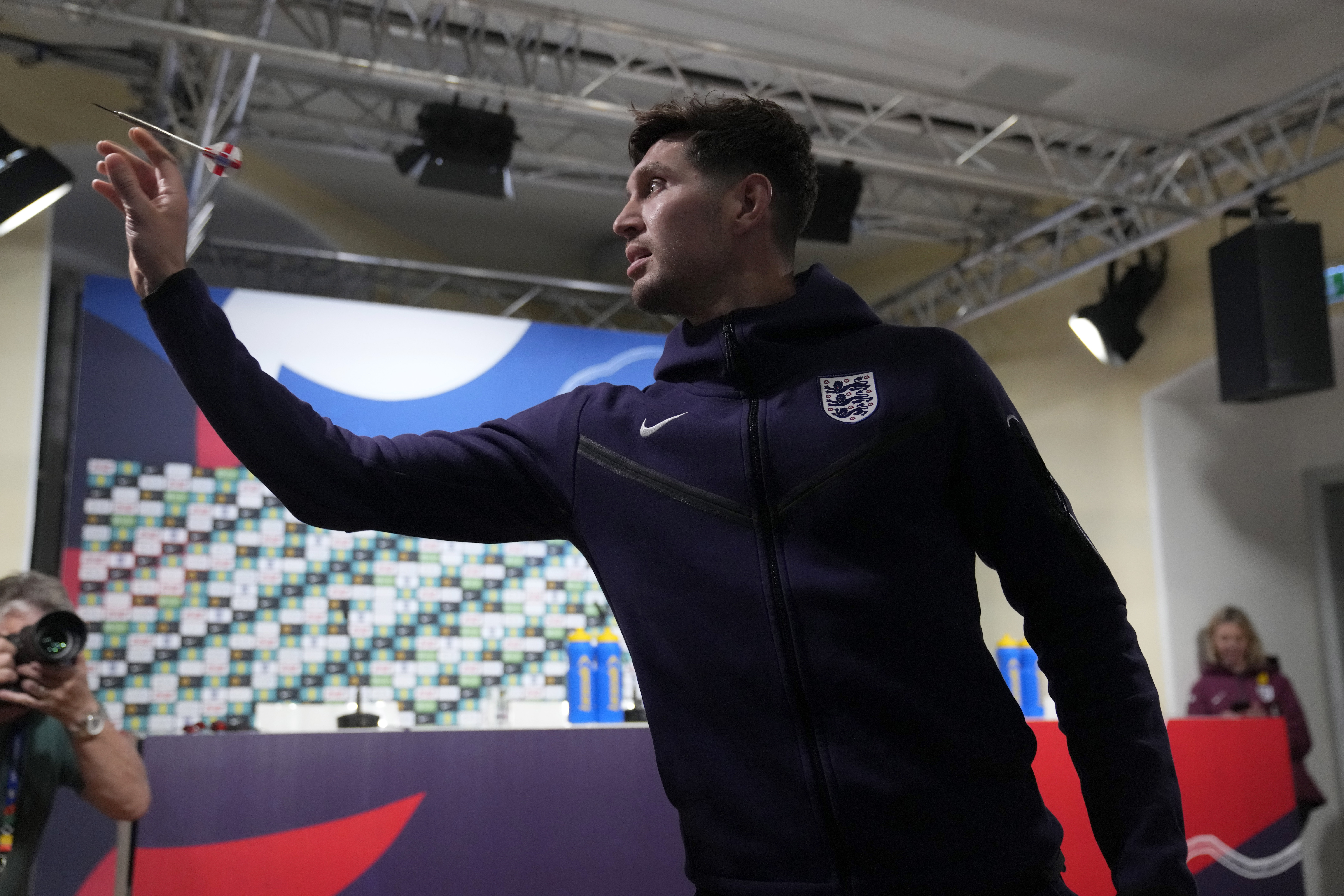 England's John Stones plays darts against a journalist before a press conference in Blankenhain, Germany, Thursday, July 4, 2024 ahead of the quarter final match against Switzerland at the Euro 2024 soccer tournament.