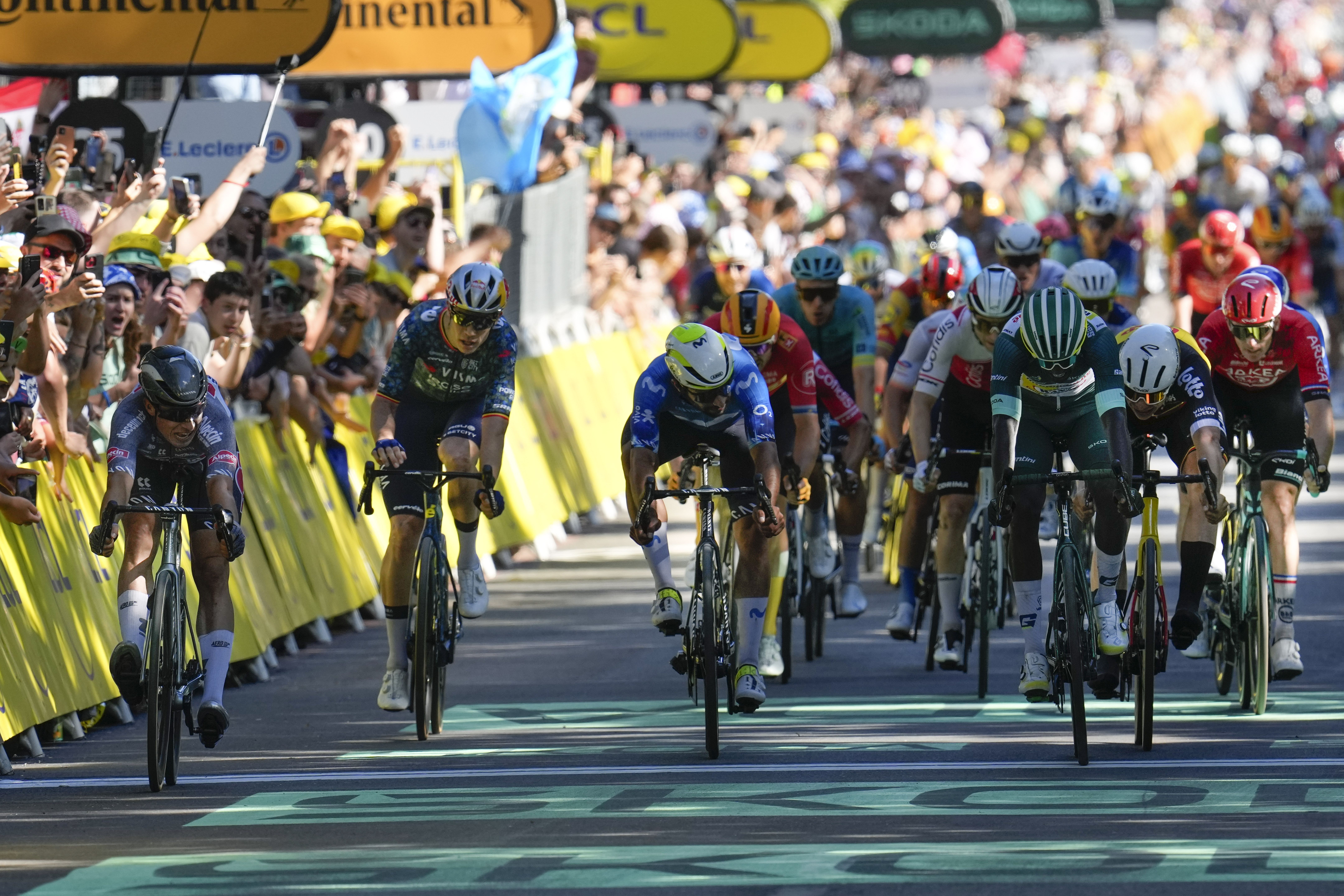 Belgium's Jasper Philipsen, left, sprints to take second place ahead f third place Eritrea's Biniam Girmay, wearing the best sprinter's green jersey, during the sixth stage of the Tour de France cycling race over 163.5 kilometers (101.6 miles) with start in Macon and finish in Dijon, France, Thursday, July 4, 2024. 