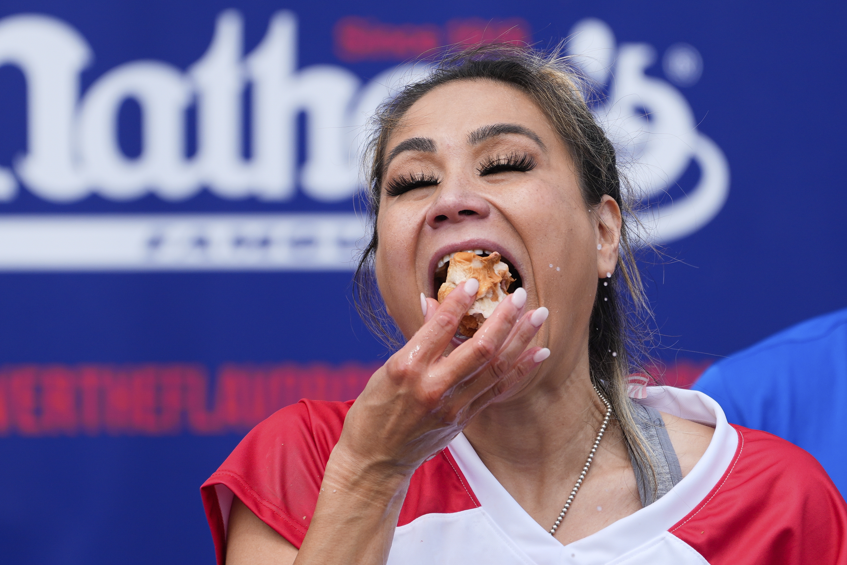 Miki Sudo competes in the women's division of Nathan's Famous Fourth of July hot dog eating contest, Thursday, at Coney Island in the Brooklyn borough of New York.