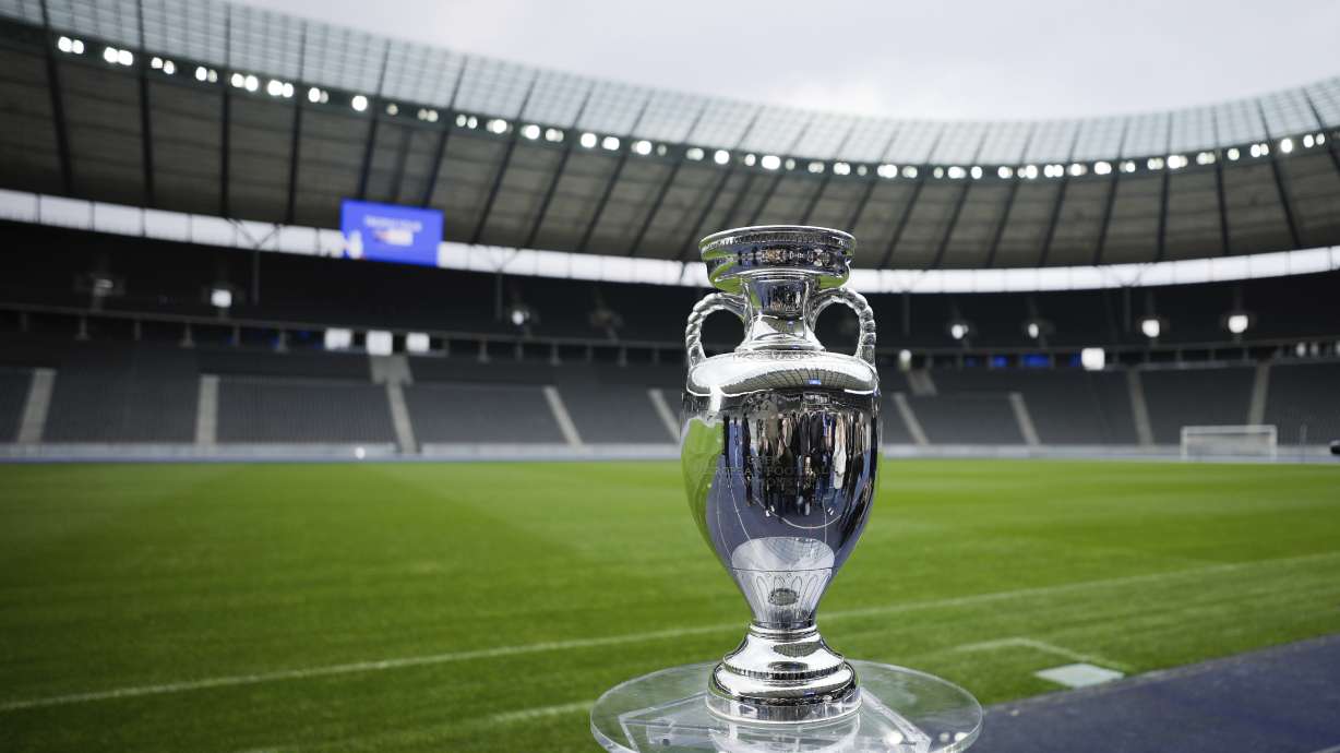 FILE - The trophy is on display during the presentation of the European soccer championship 'EURO 2024' trophy at the Olympic Stadium in Berlin, Germany, Wednesday, April 24, 2024. The Euros kick off in Munich, Friday June 14, when host country Germany plays Scotland at Bayern Munich's Allianz Arena. The tournament begins with six groups of four teams.