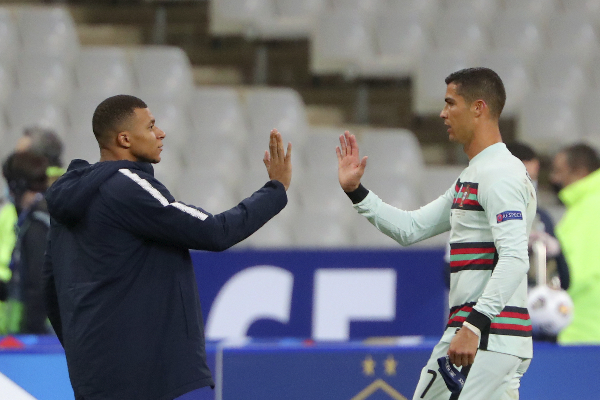 FILE - In this Sunday, Oct. 11, 2020 file photo France's Kylian Mbappe and Portugal's Cristiano Ronaldo, right, greet each other before the Nations League soccer match between France and Portugal at the Stade de France in Saint-Denis, north of Paris, France. Cristiano Ronaldo vs. Kylian Mbappe is not just a clash of soccer icons but a clash of generations. They’ll go head to head when Portugal plays France in the Euro 2024 quarterfinals on Friday and their heavyweight meeting just got a little bit bigger after Ronaldo said this would be his last European Championship. 