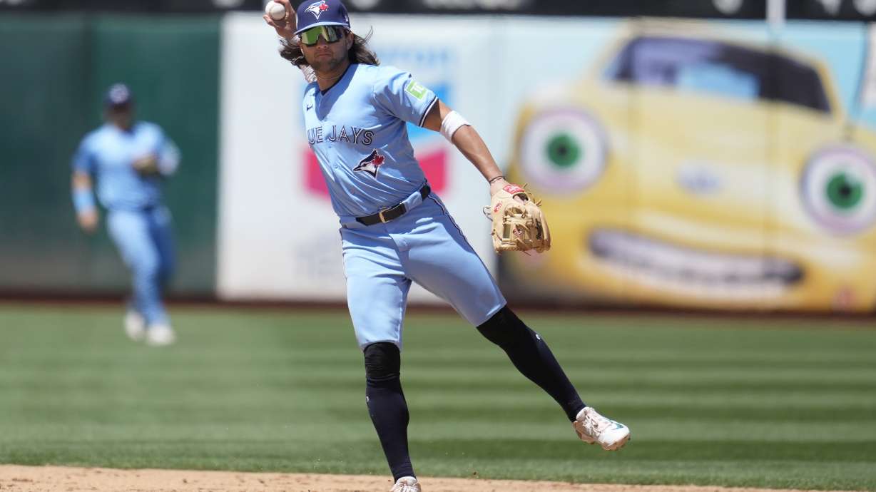 Toronto Blue Jays shortstop Bo Bichette throws out Oakland Athletics' JJ Bleday at first base during the sixth inning of a baseball game in Oakland, Calif., Sunday, June 9, 2024.